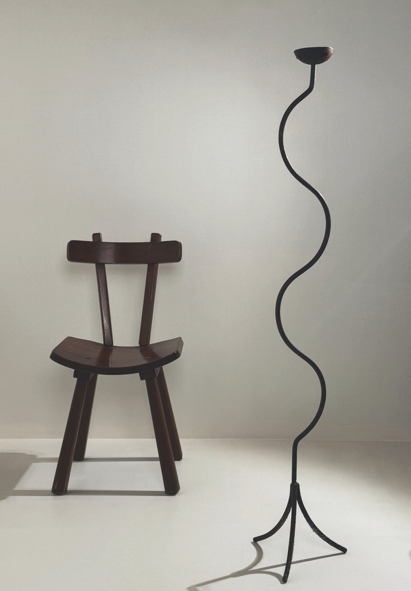 Large sculptural wrought iron candleholder with curved snake-like stem