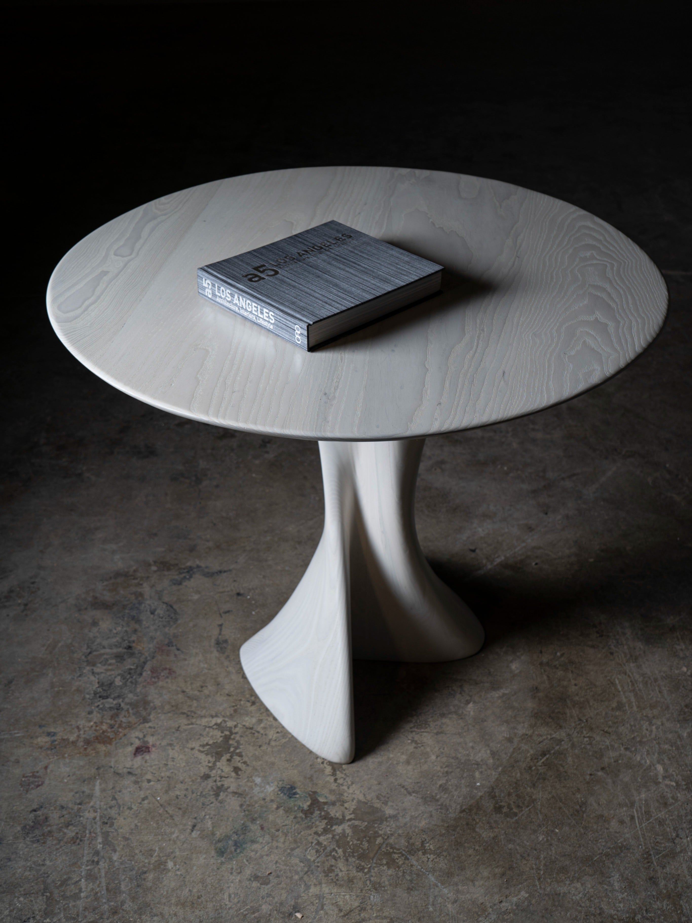 Sculptural Dervish Table in Ash wood Ebony stain — lifestyle setting
