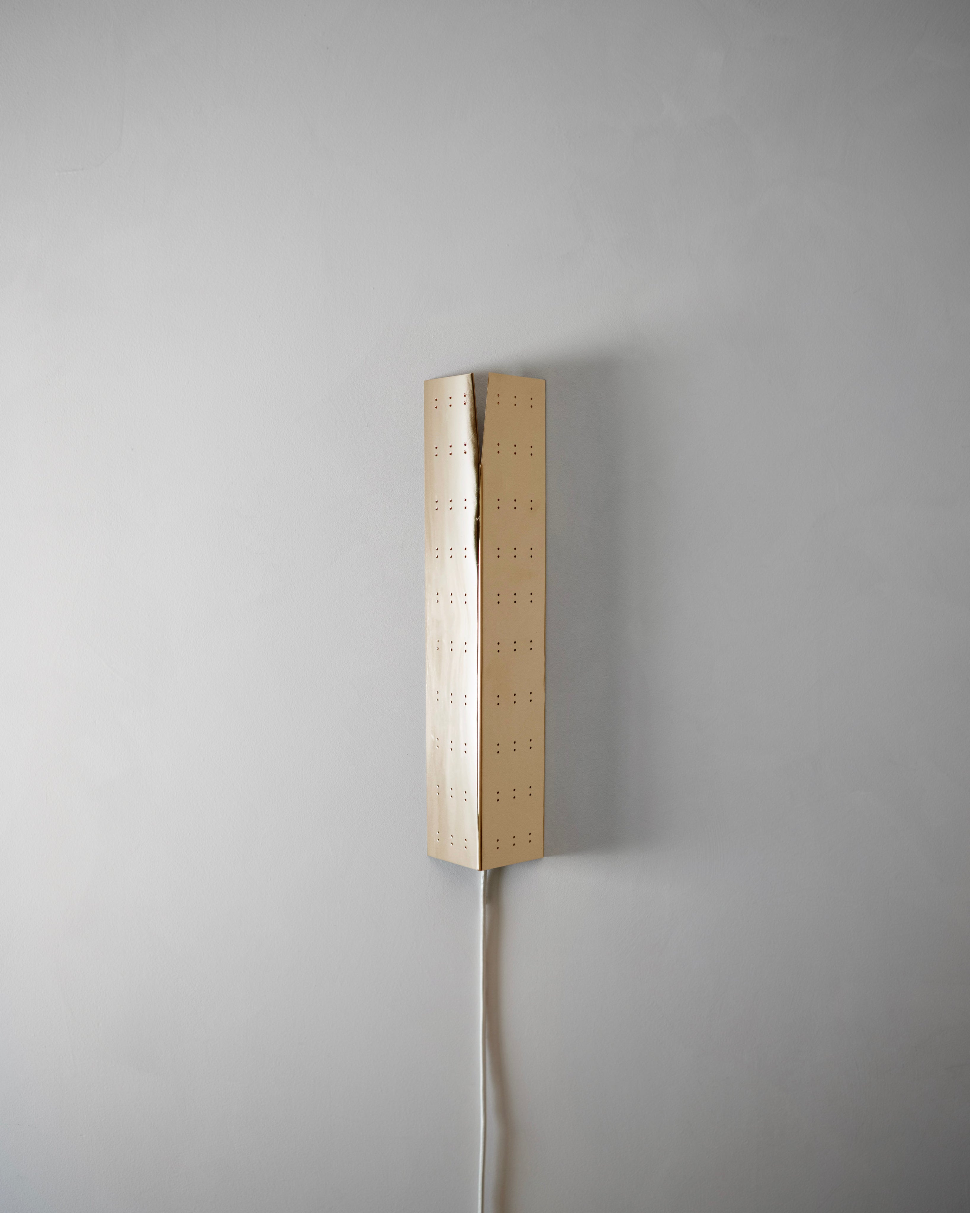 May Wall Lamp - Polished Brass — mounted on light gray wall