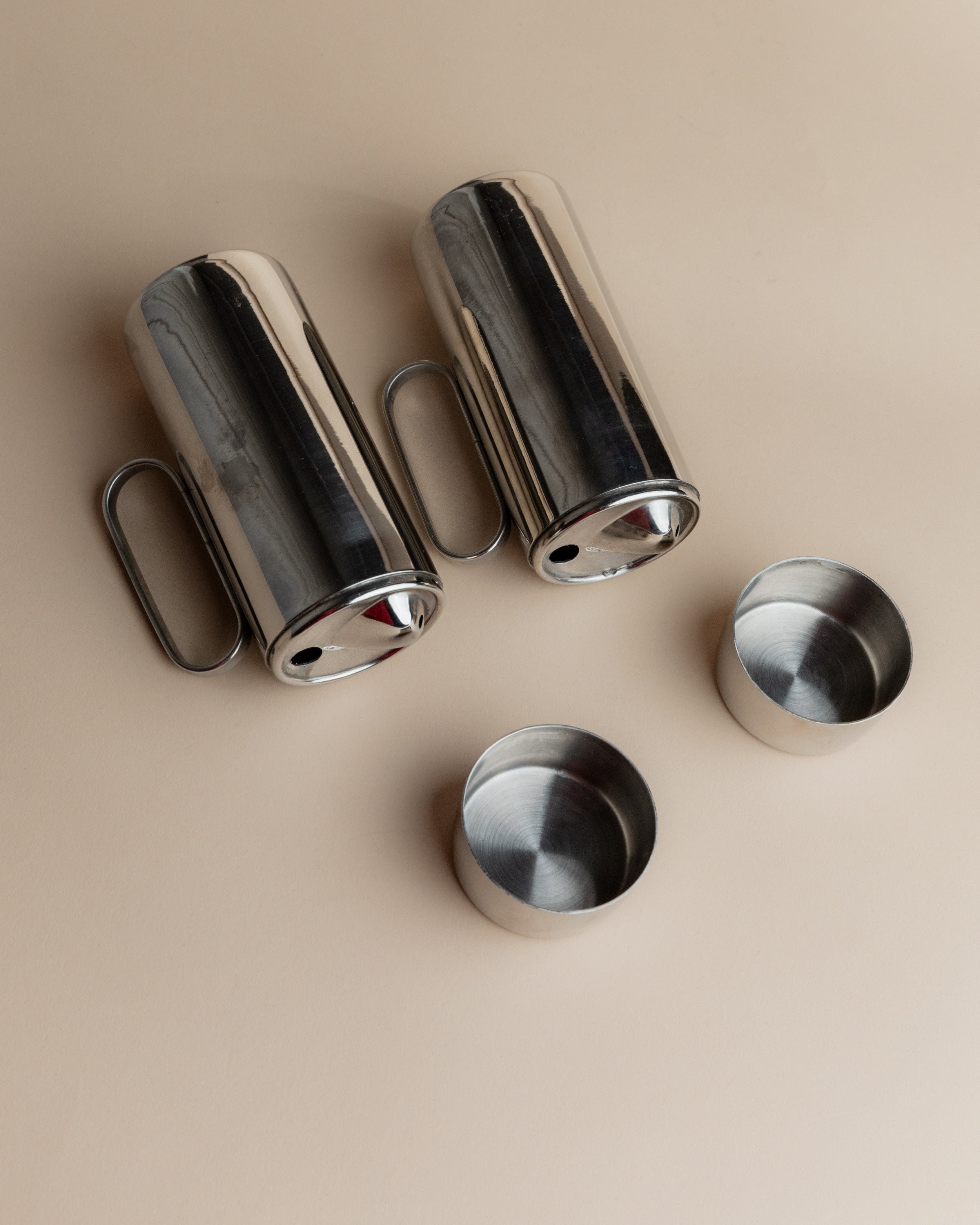 Disassembled 1980s stainless steel oil and vinegar cruet set components