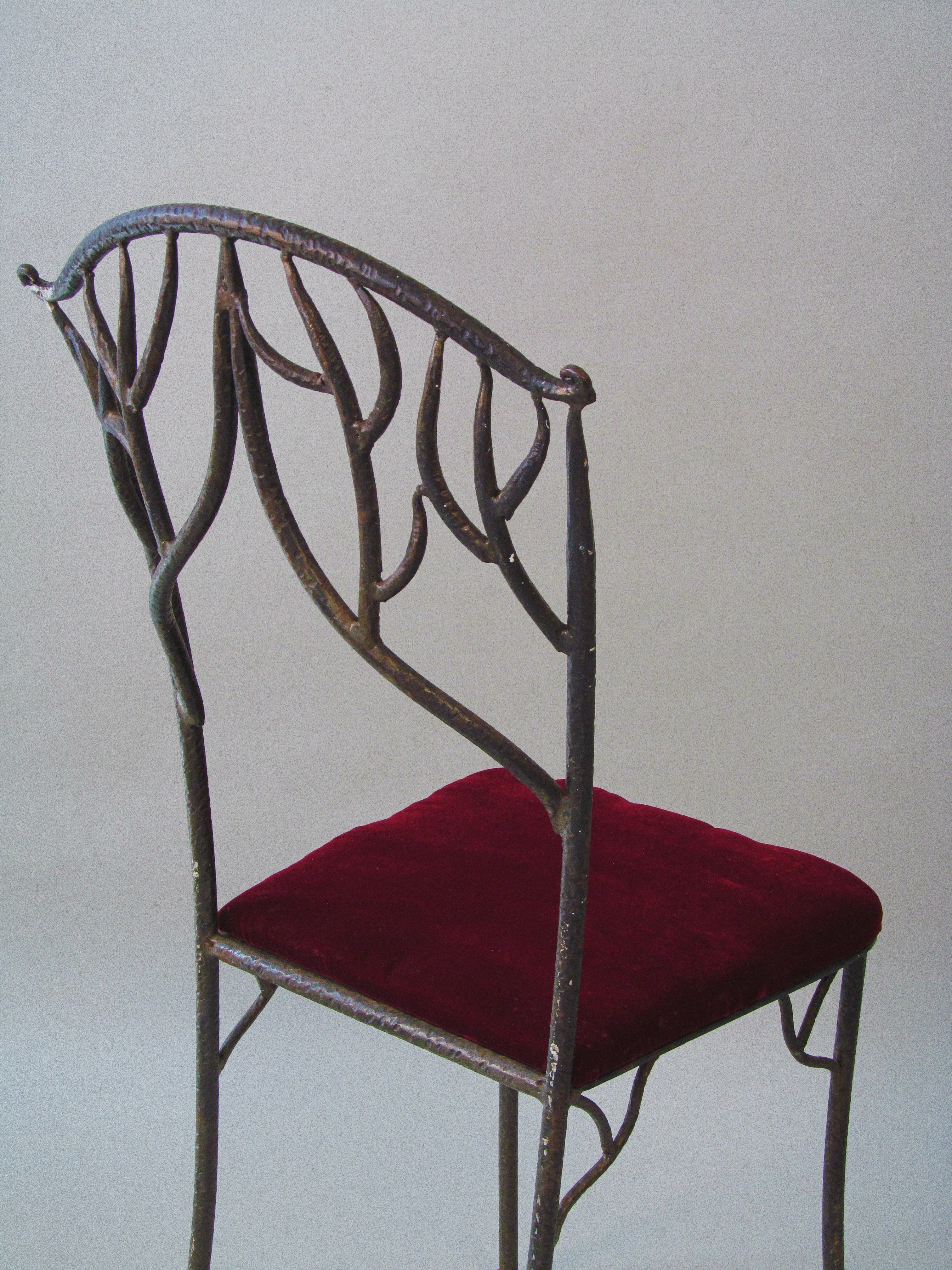 Fer Forgé Dining Chairs (Pair) — side view of wrought iron frame with red seat
