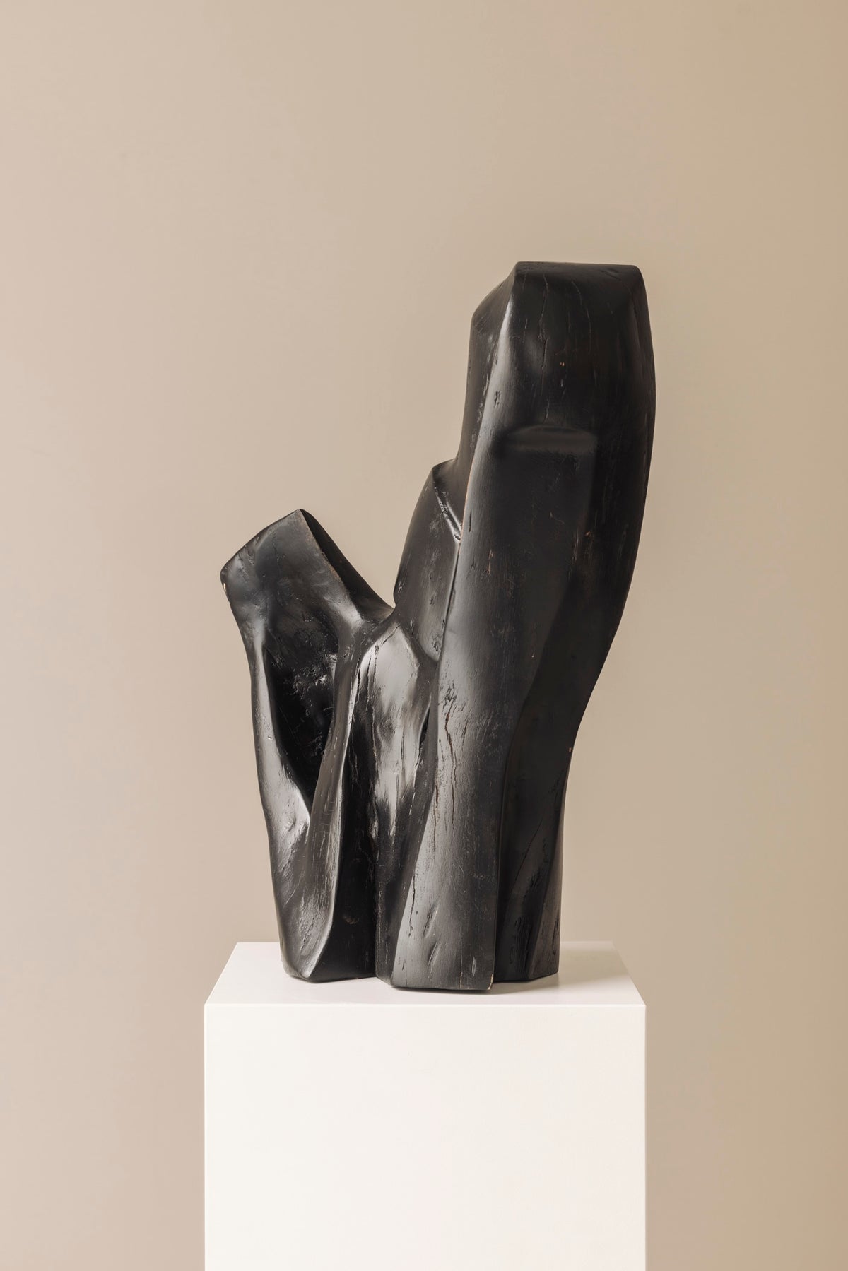 Abstract sculpture in solid dark stained wood dating from the 1950s. — alternate view