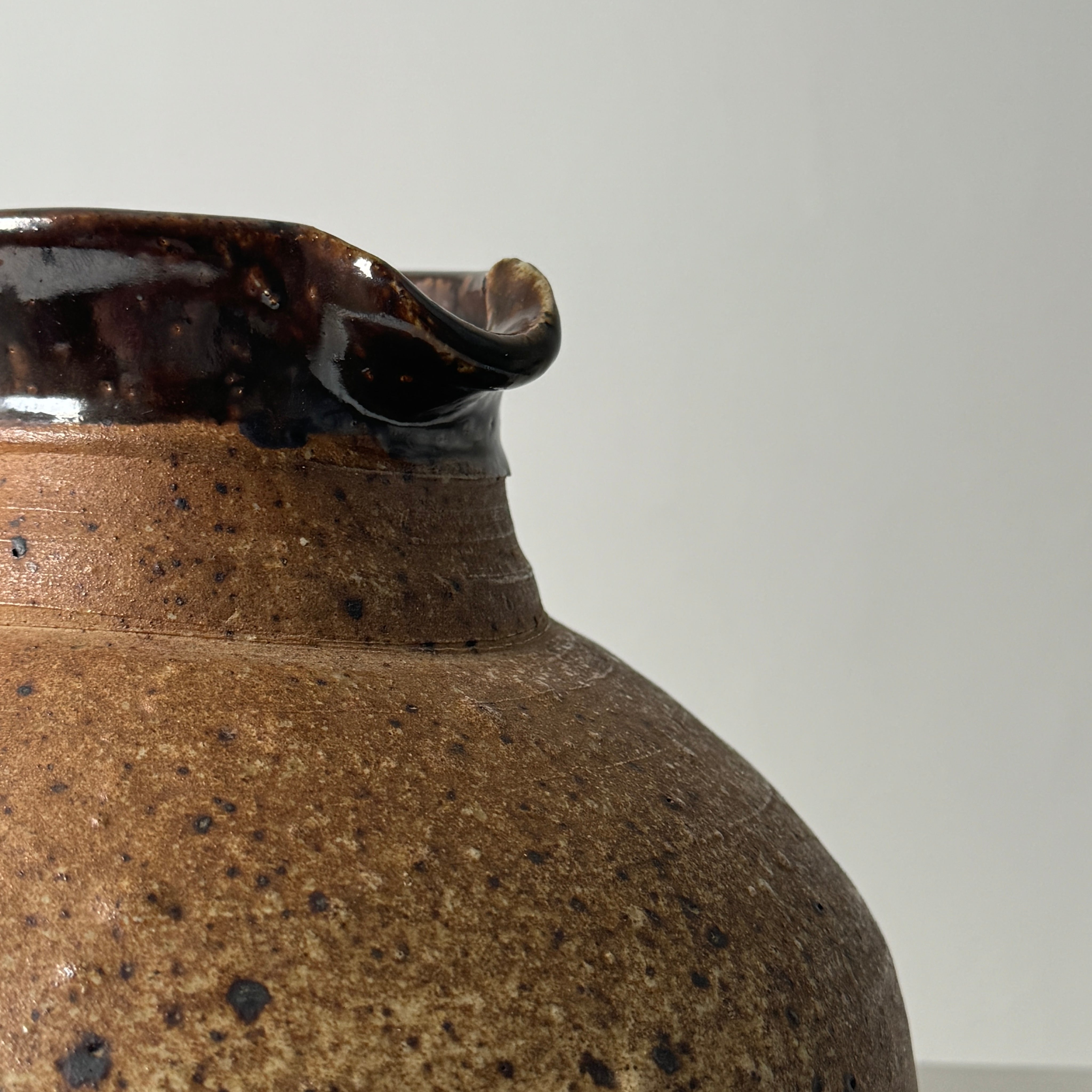 Close-up detail of glazed ceramic pitcher spout by Pierre Digan