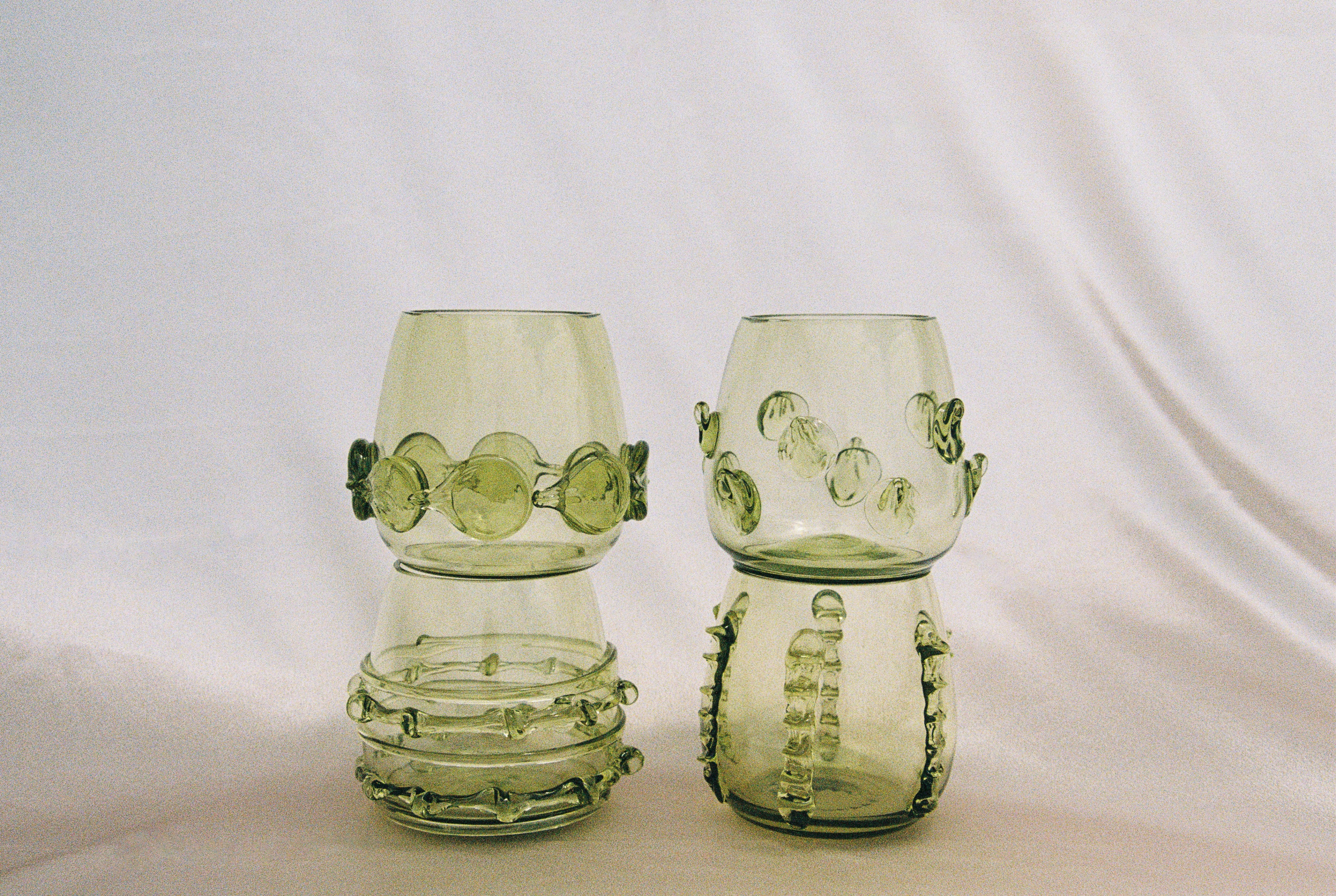 Contemporary Tumblr - Set of four handblown glass vessels - stacked on soft fabric background
