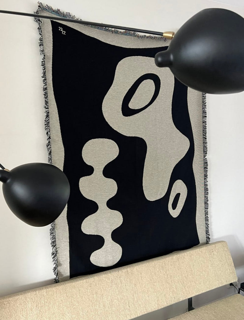 Teuru jacquard throw with black and cream abstract pattern