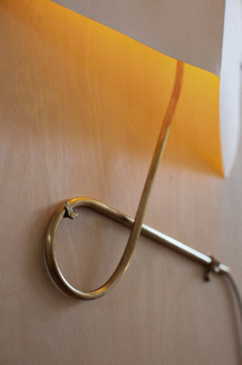 Wall Light - Papēr I — close-up of brass arm with orange shade