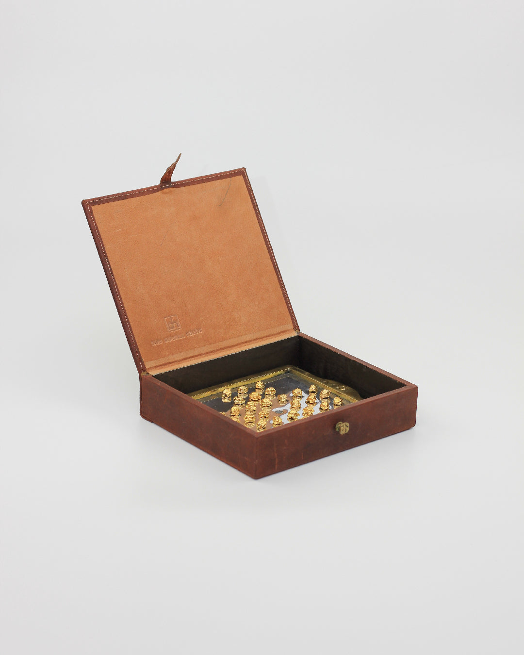 Solitario Inglés — top view of brown leather box with gold pieces