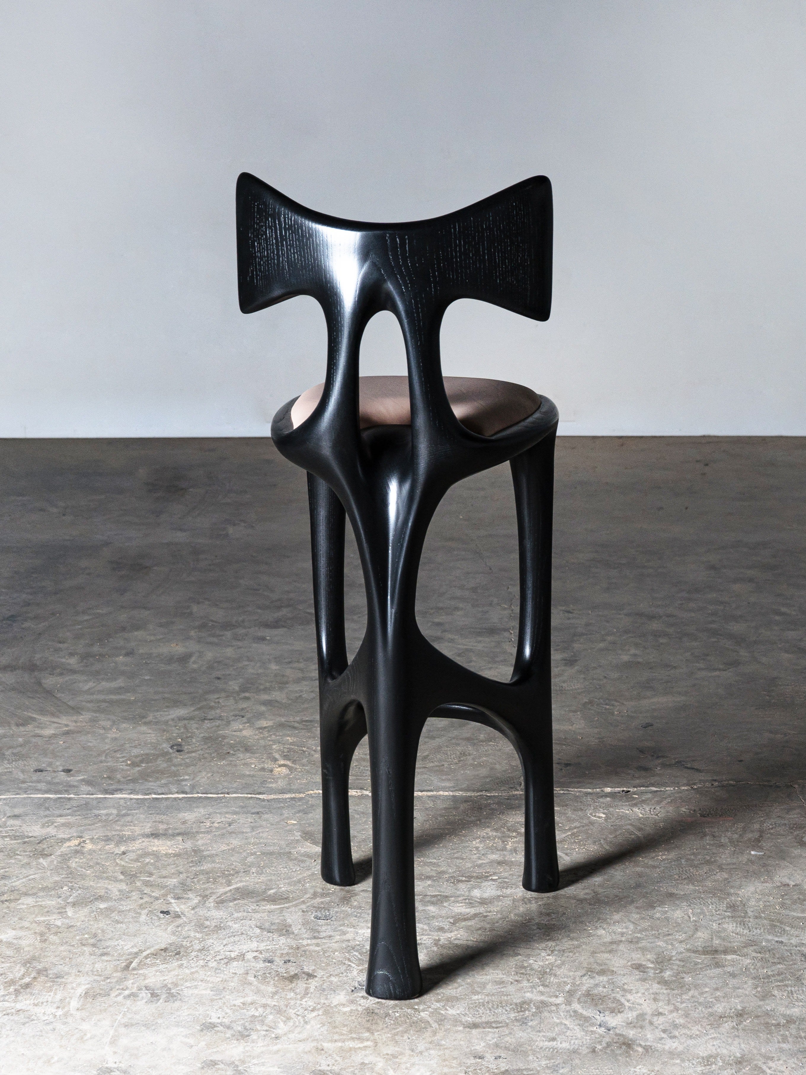 Tripa Stool in Ebony stain on Ash Wood — side angle showing unique leg design