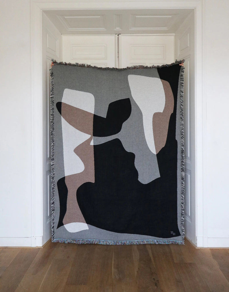 Owinge abstract geometric jacquard throw in black, grey and beige