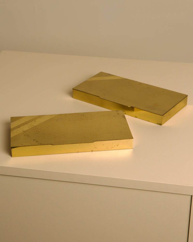 Two golden brass Italian boxes from 1960s on white surface