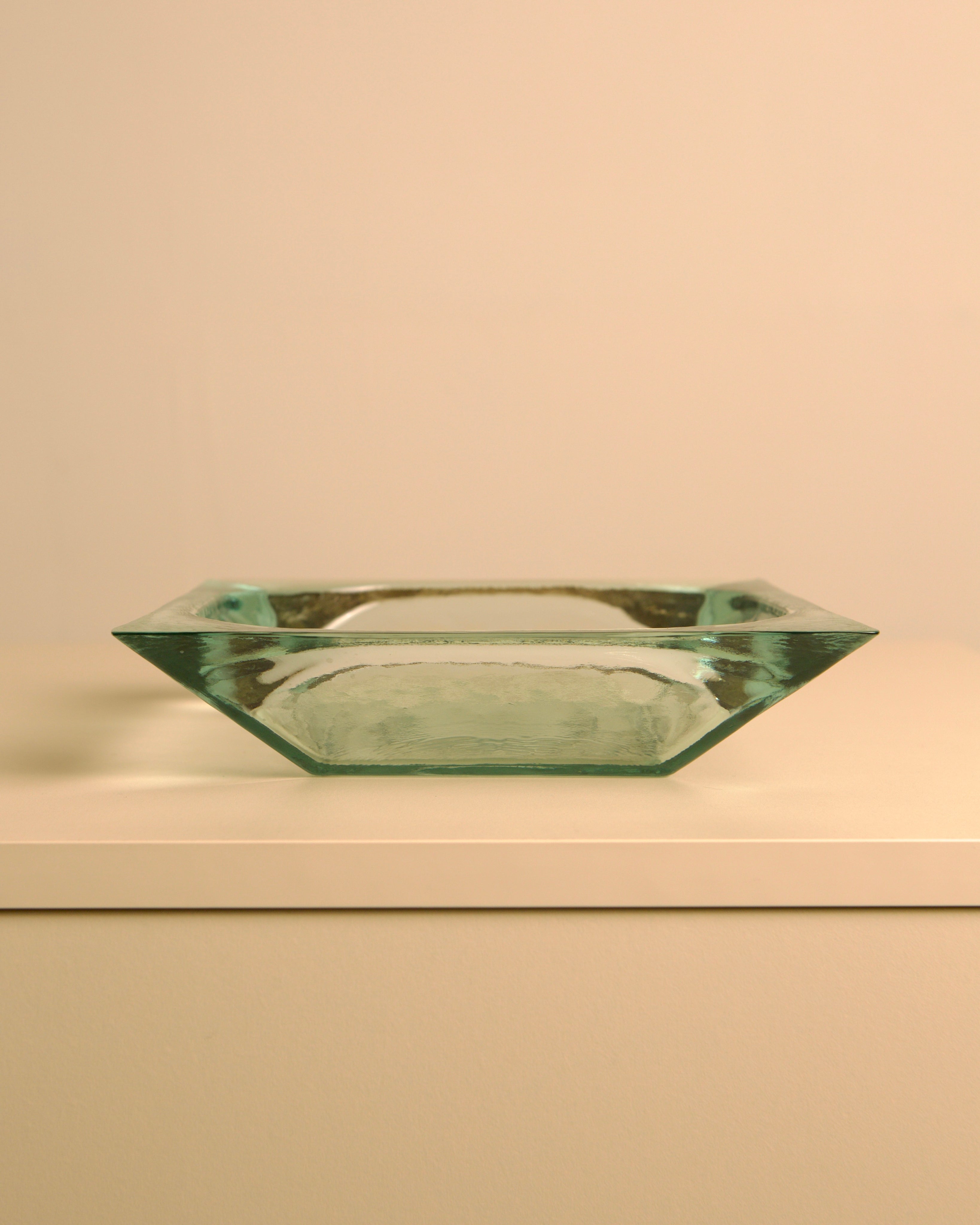 Large Italian glass basket by Fontana Arte — side angle on white surface