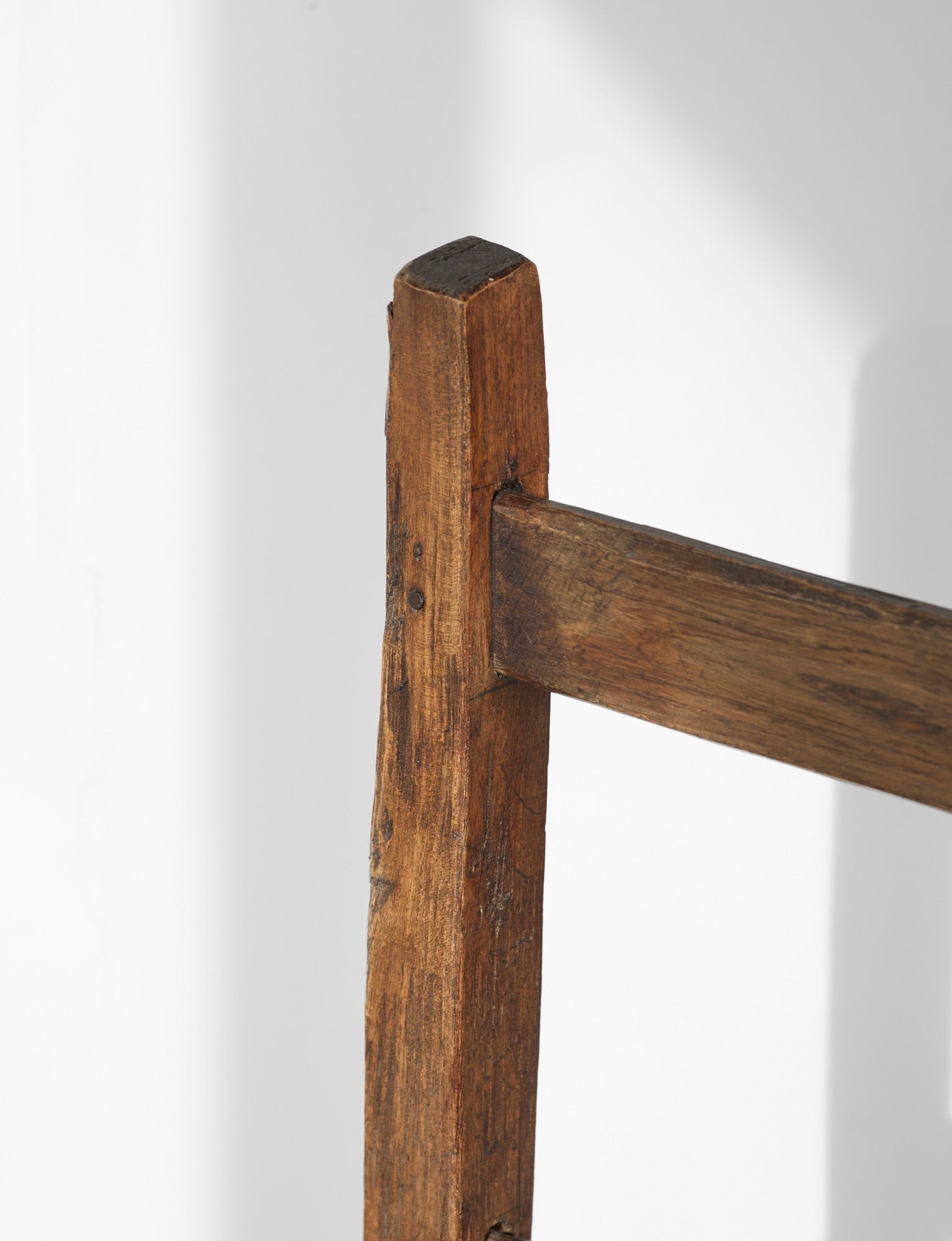 A French folk bench from the 19th Century. Wood and straw — side angle