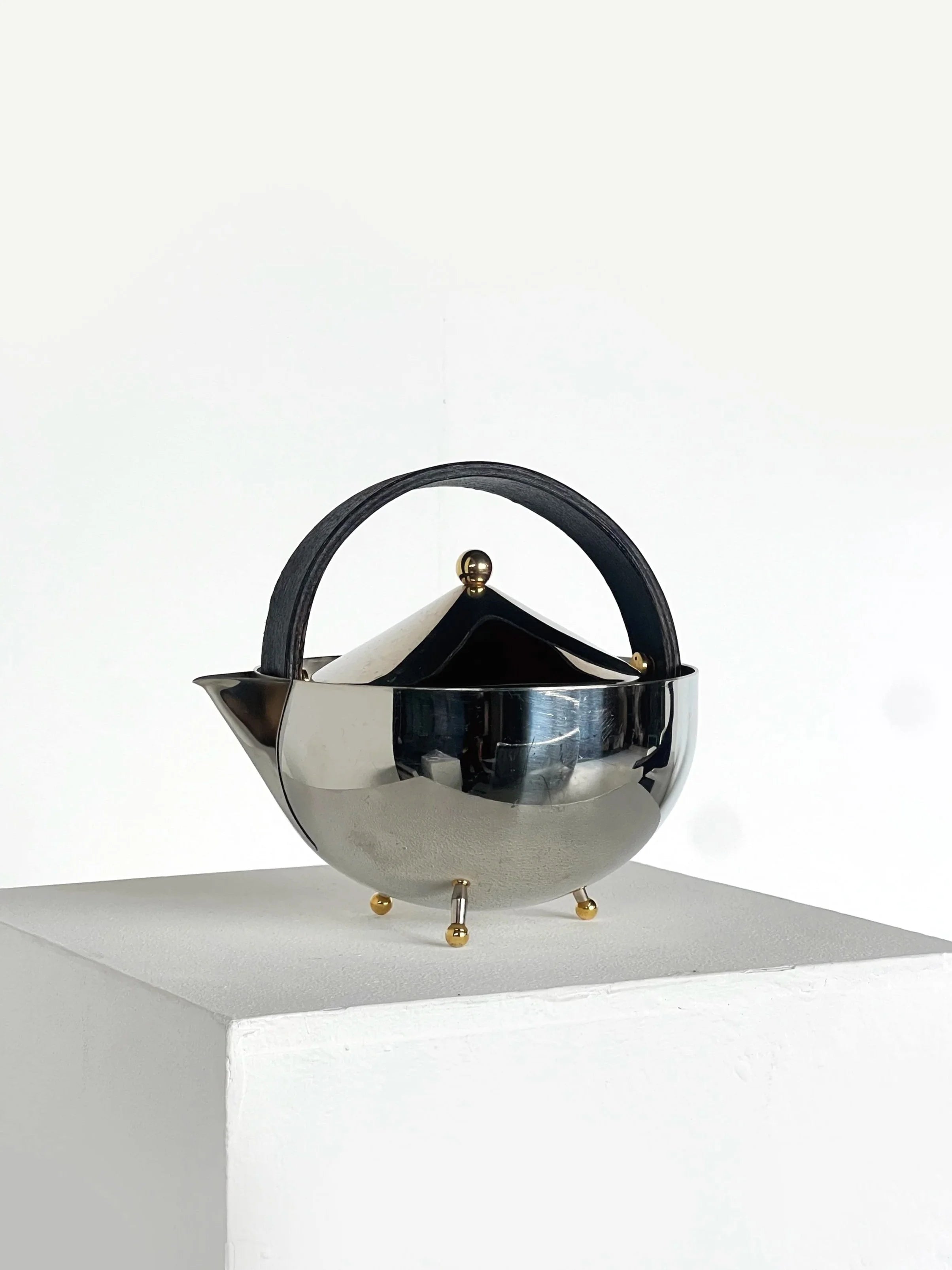 Carsten Jørgensen Teapot — side angle showing polished metal and leather handle