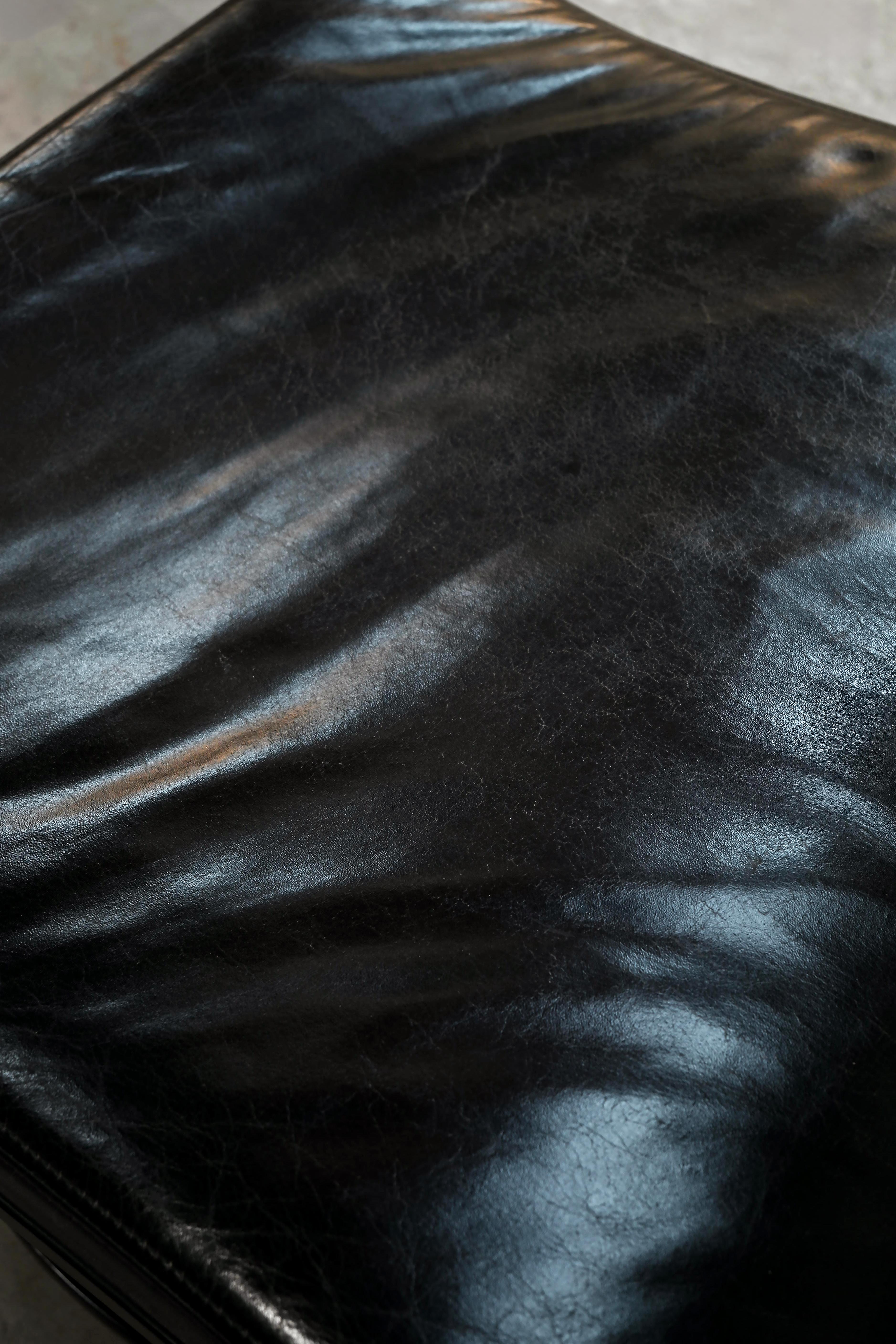 Swivel Lounge Chair and Ottoman by Takashi Okamura for Nelo Möbel Sweden — close-up of black leather upholstery
