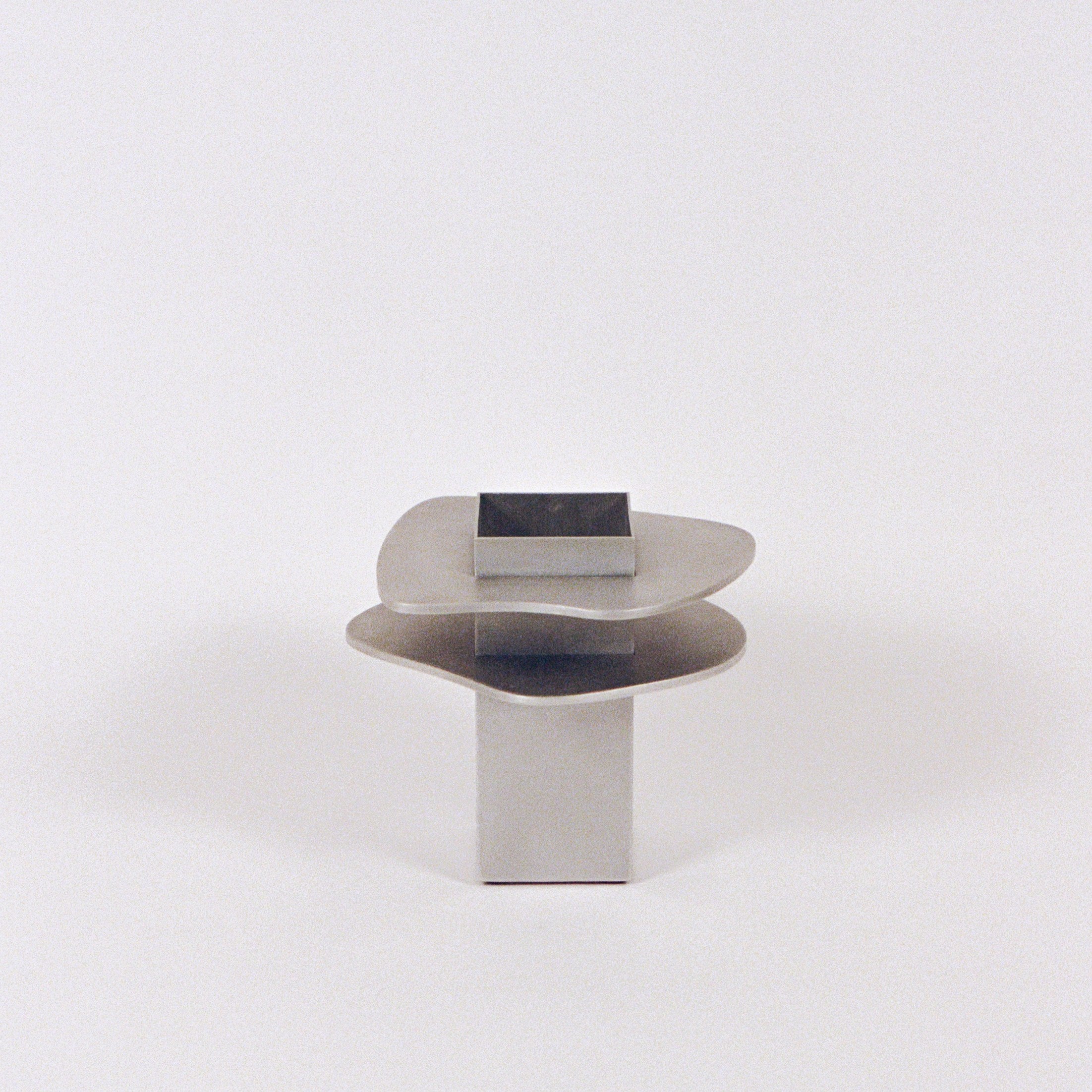 Flange Vase — side angle showing polished metal finish