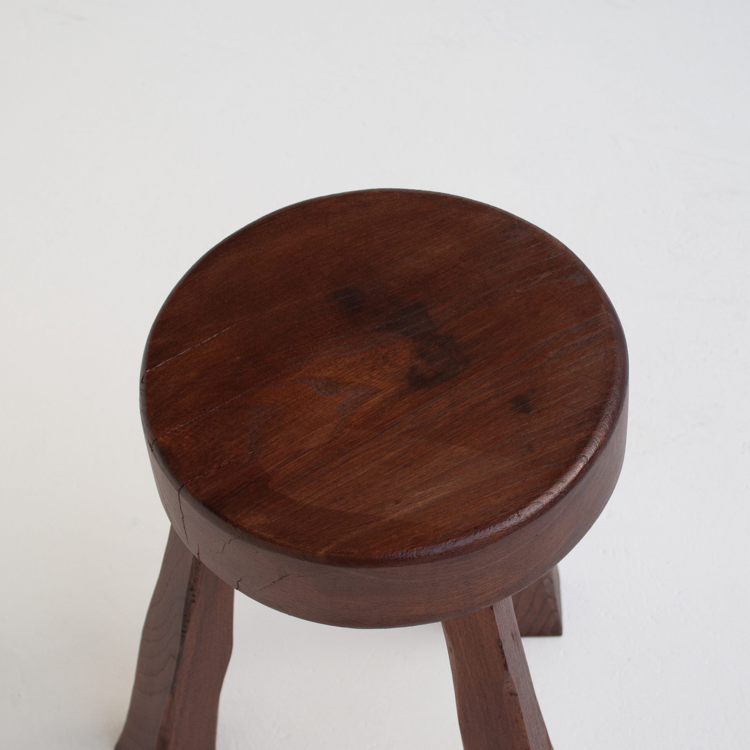 Round Wooden Stool — top view of dark wood seat