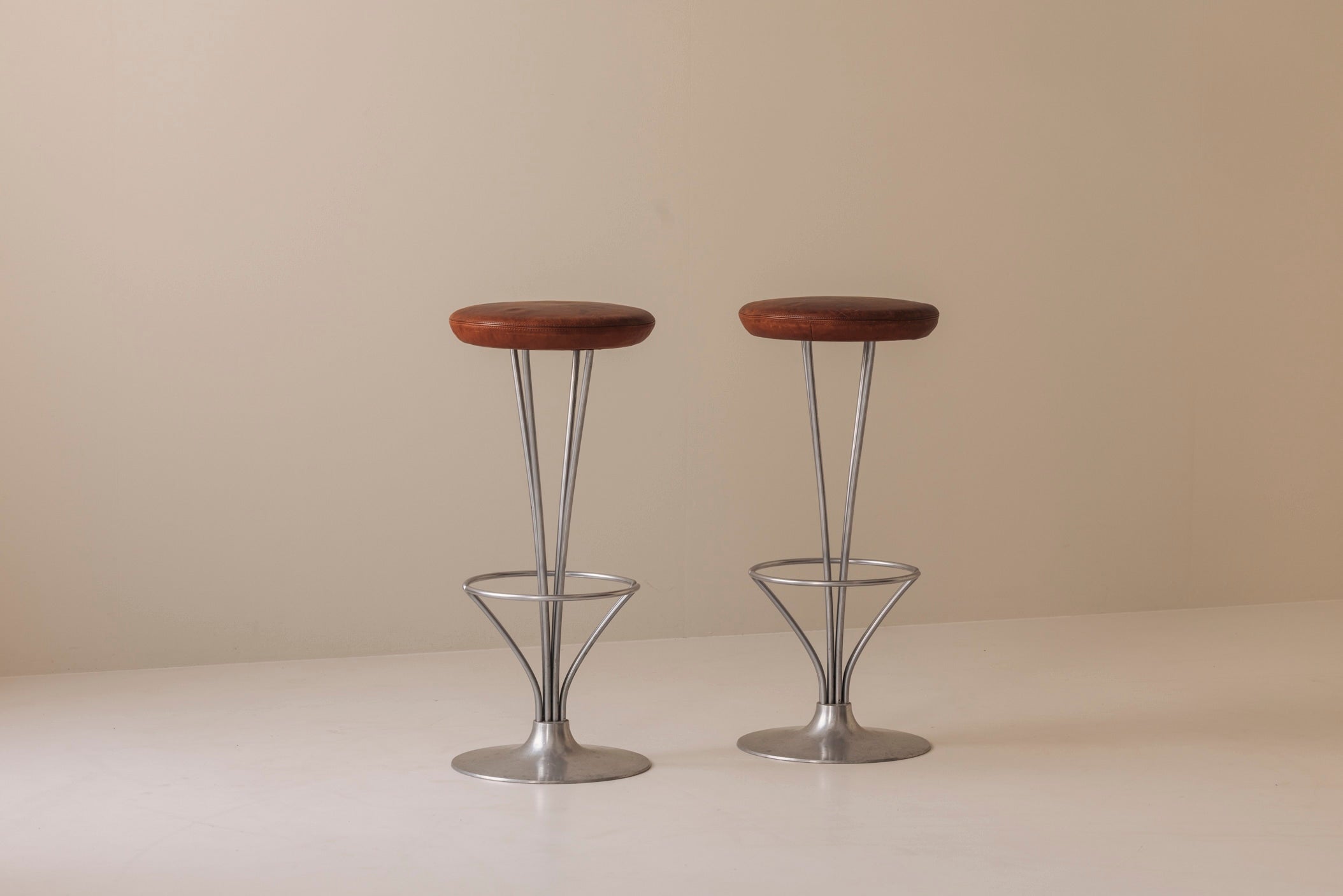 Set of Two Bar Stools in patinated leather by Piet Hein for Fritz Hansen, Denmark, 1960s — lifestyle setting