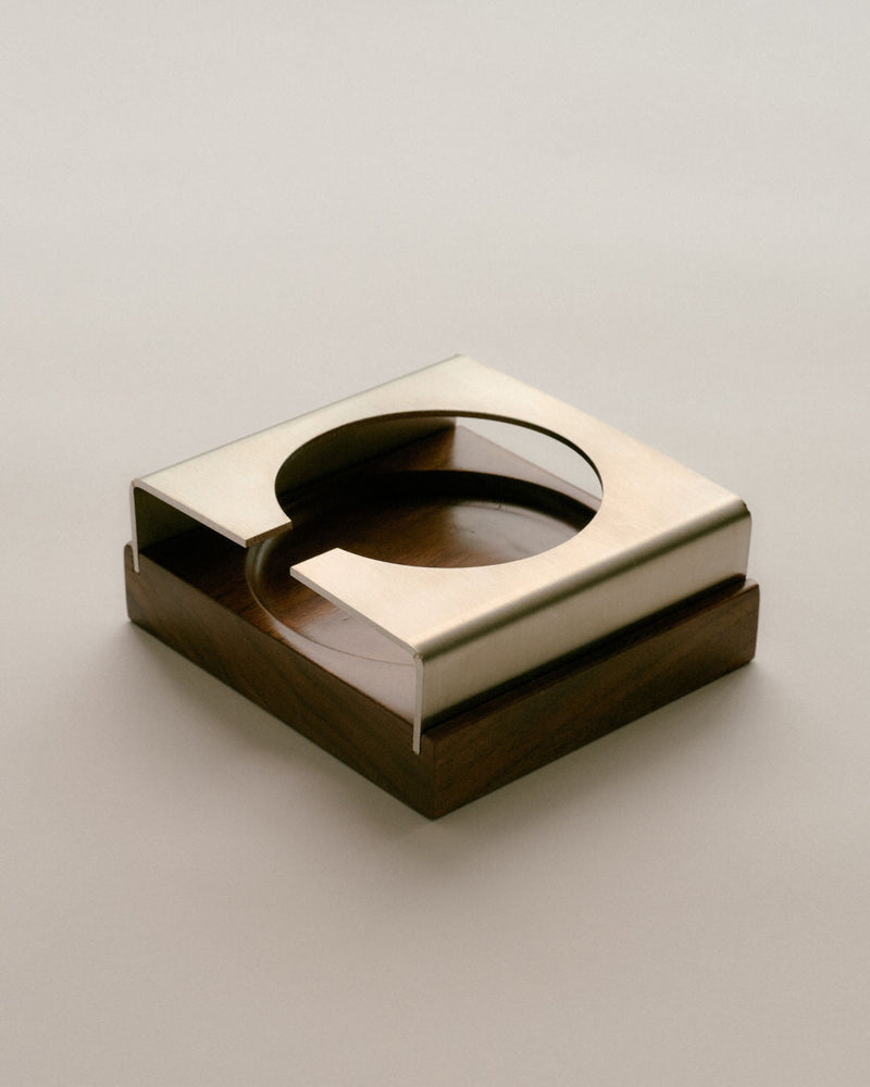 Modern square brass coaster with circular cutout detail view
