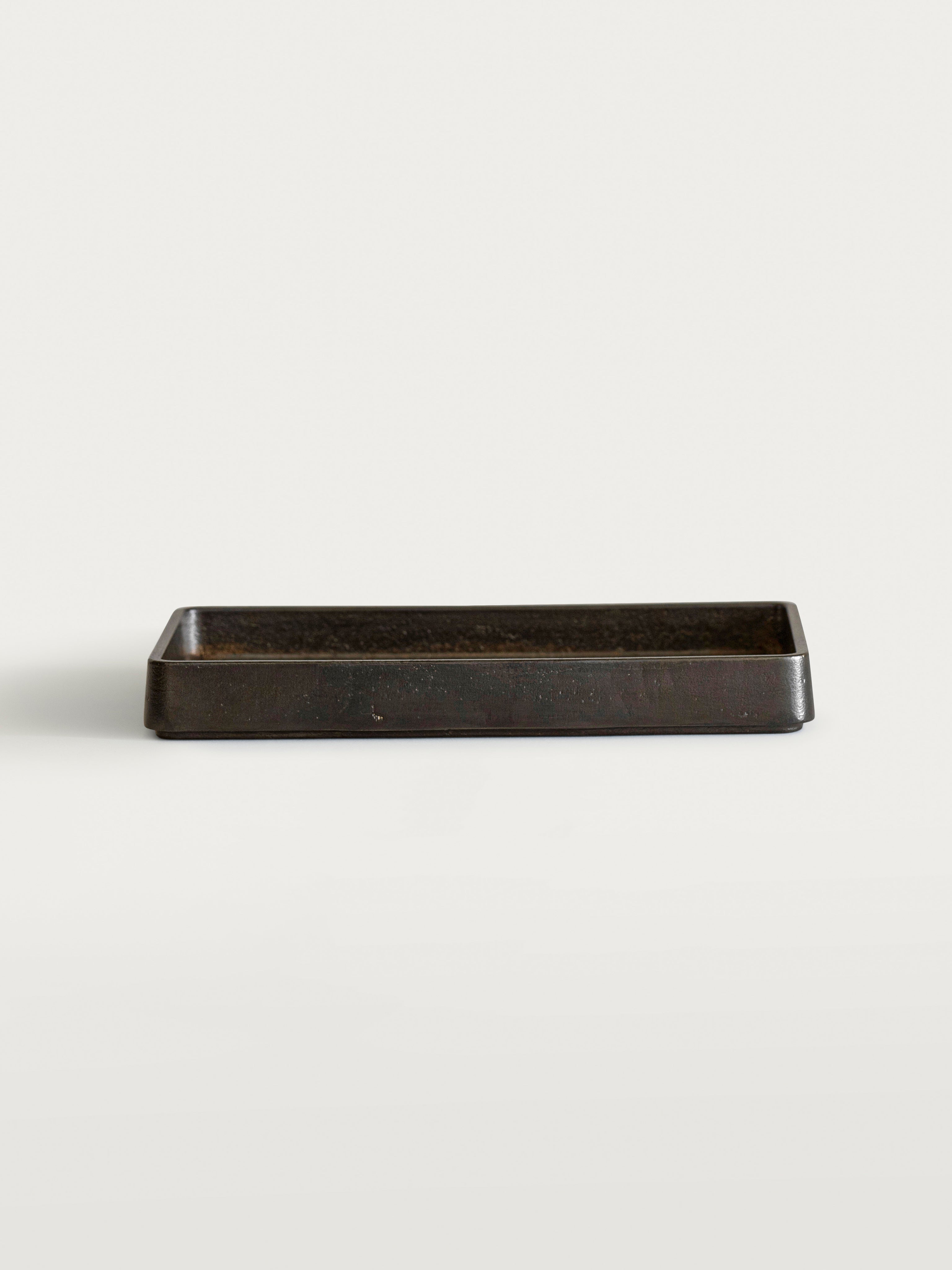 Plato Table Tray — angled view of dark metal surface