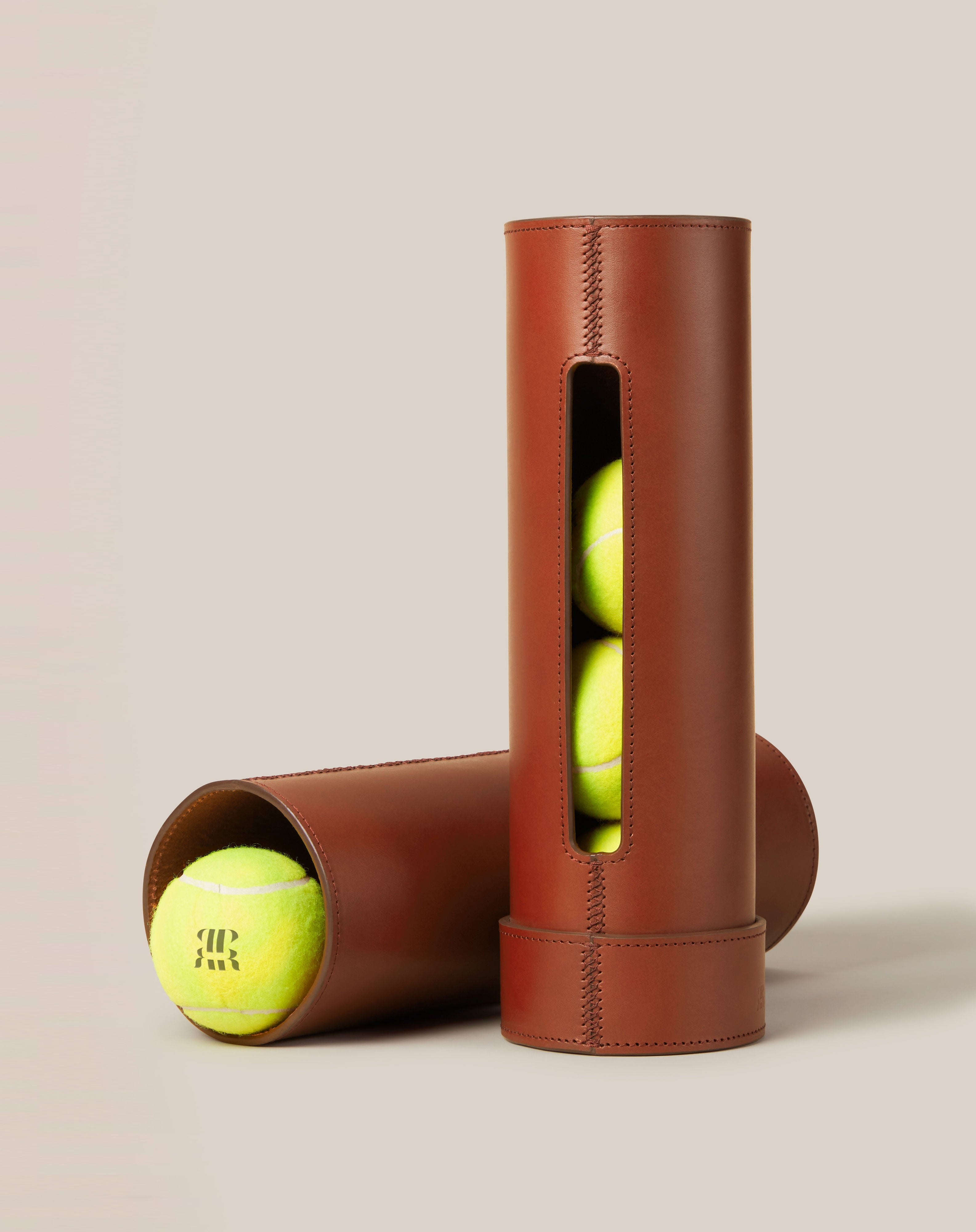 Leather Tennis Ball Holder — side view showing brown leather with tennis balls