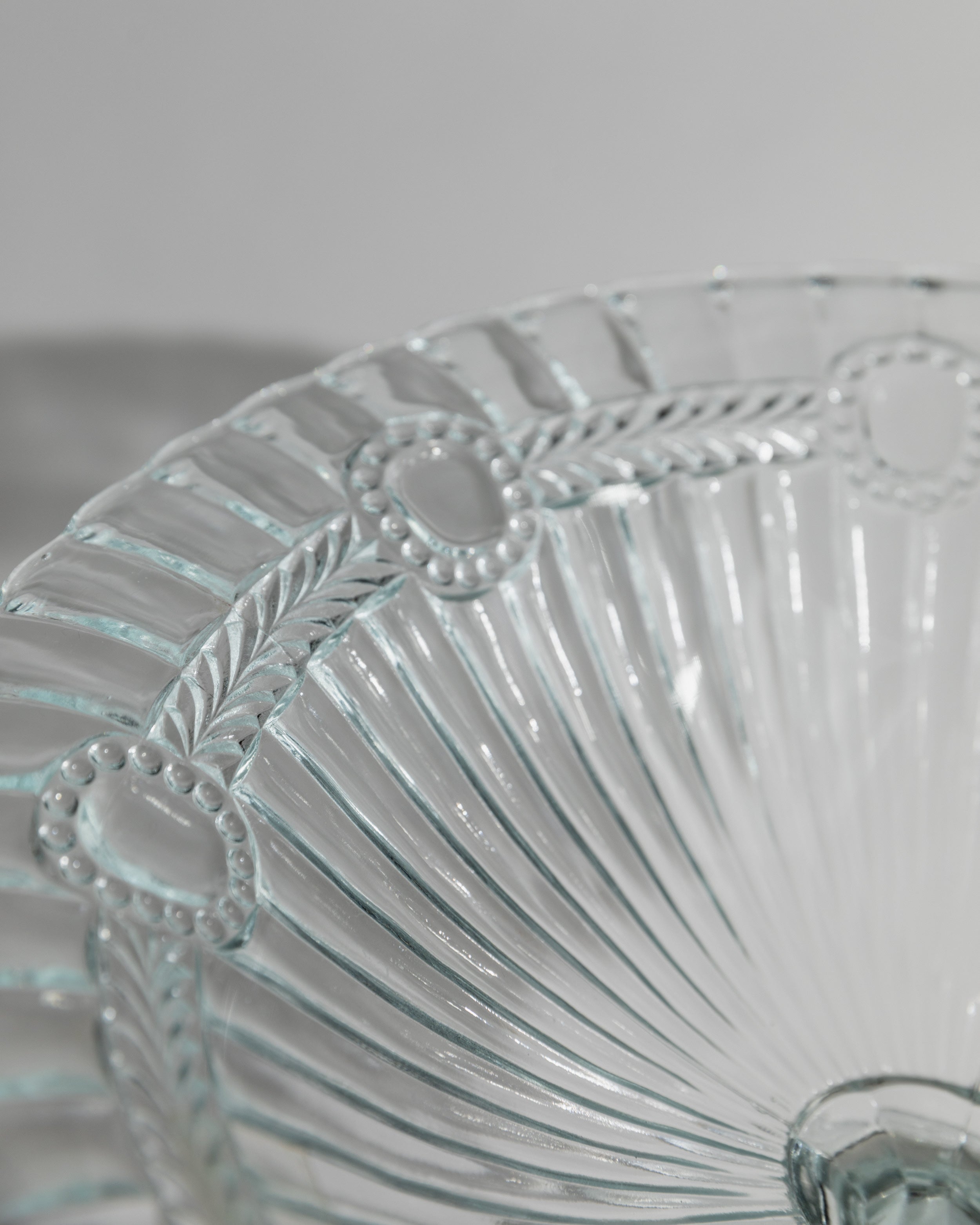 Close-up detail of ornate pressed glass serving dish from 1910s