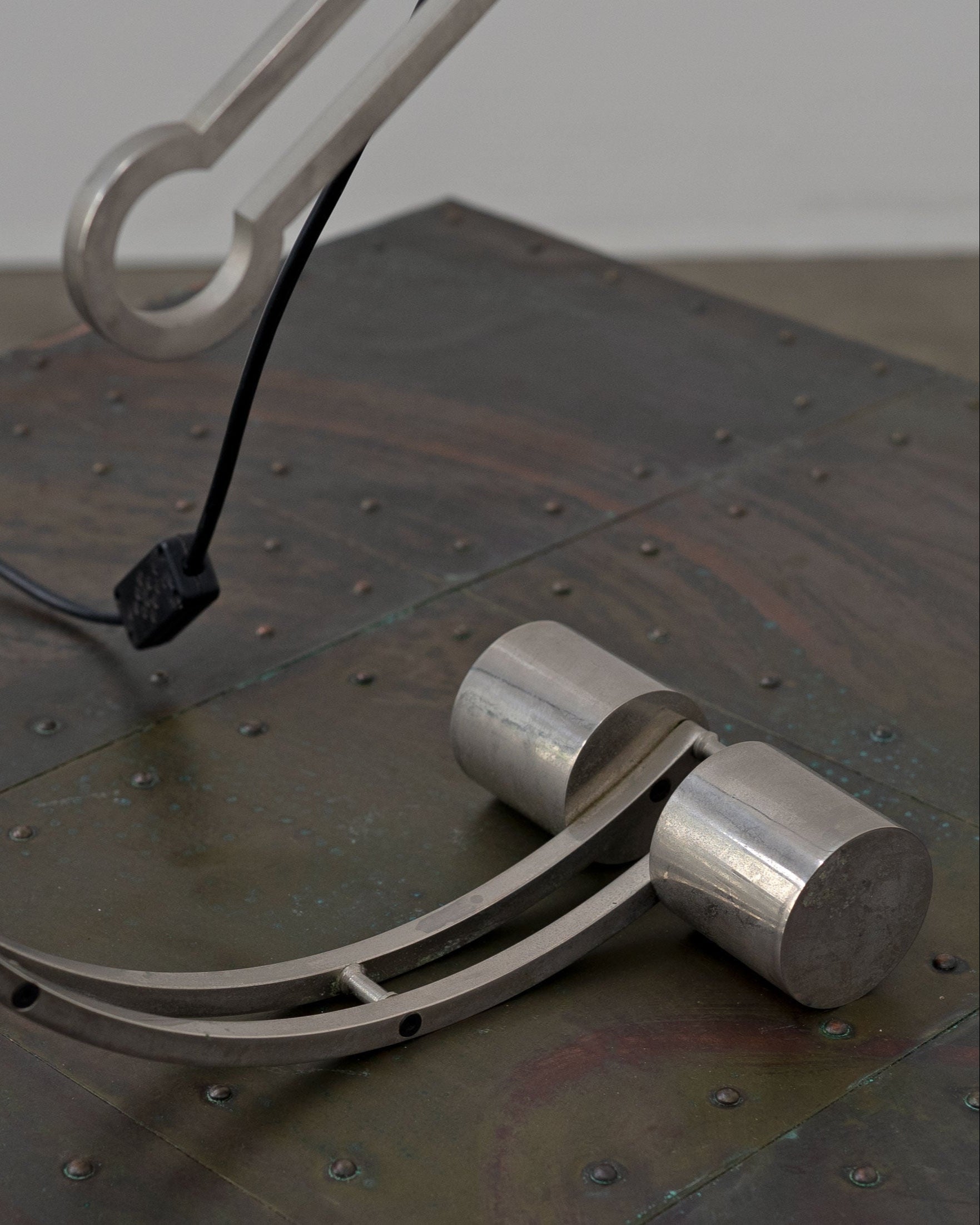Art Deco table lamp detail showing curved metal arm and base