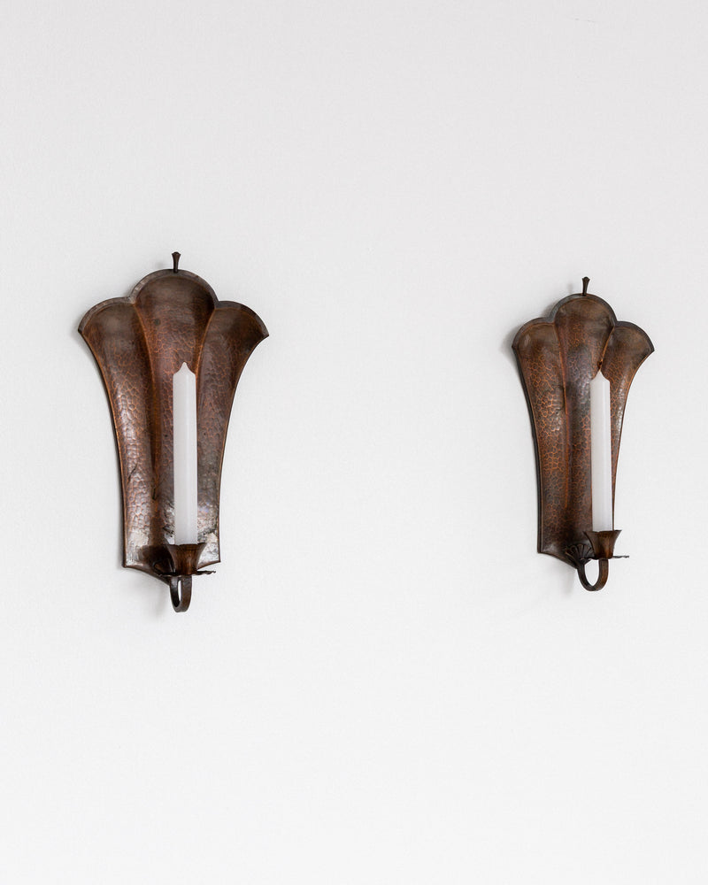 Pair of Swedish Art Deco Copper Wall Sconces, 1930s — close-up of textured copper surface on white wall