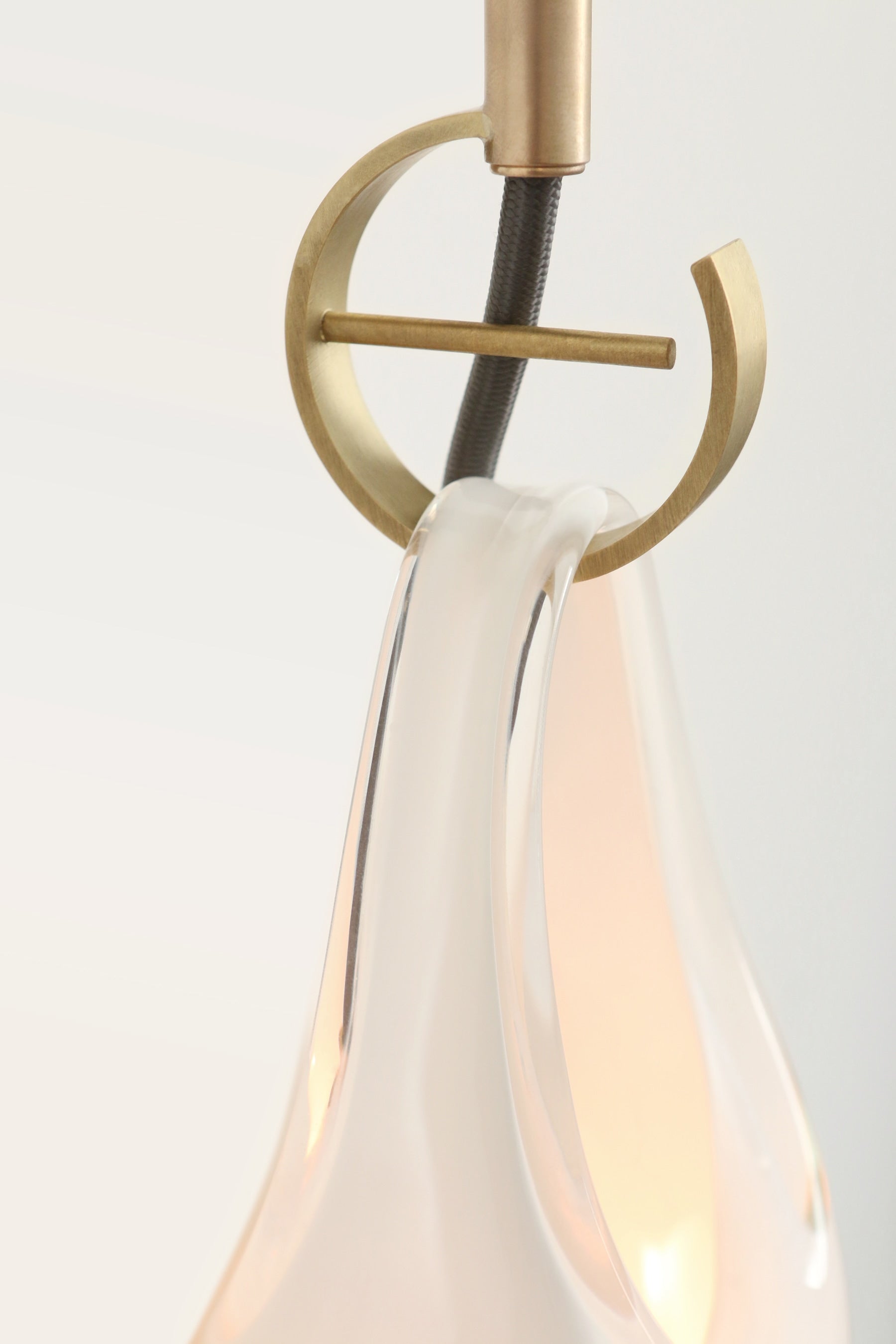 SkLO Hold 12 Sconce, White Glass, Brushed Brass, Black Cord — lifestyle setting