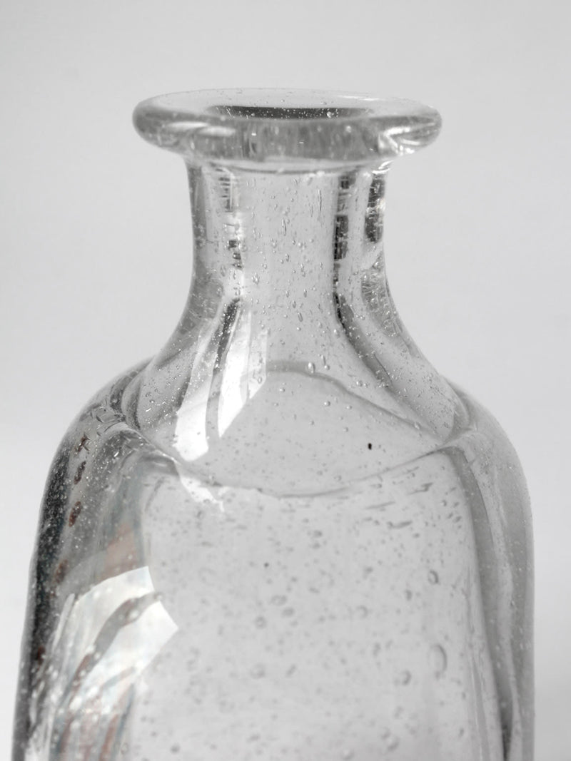 Close-up detail of vintage bubble glass bottle neck and rim