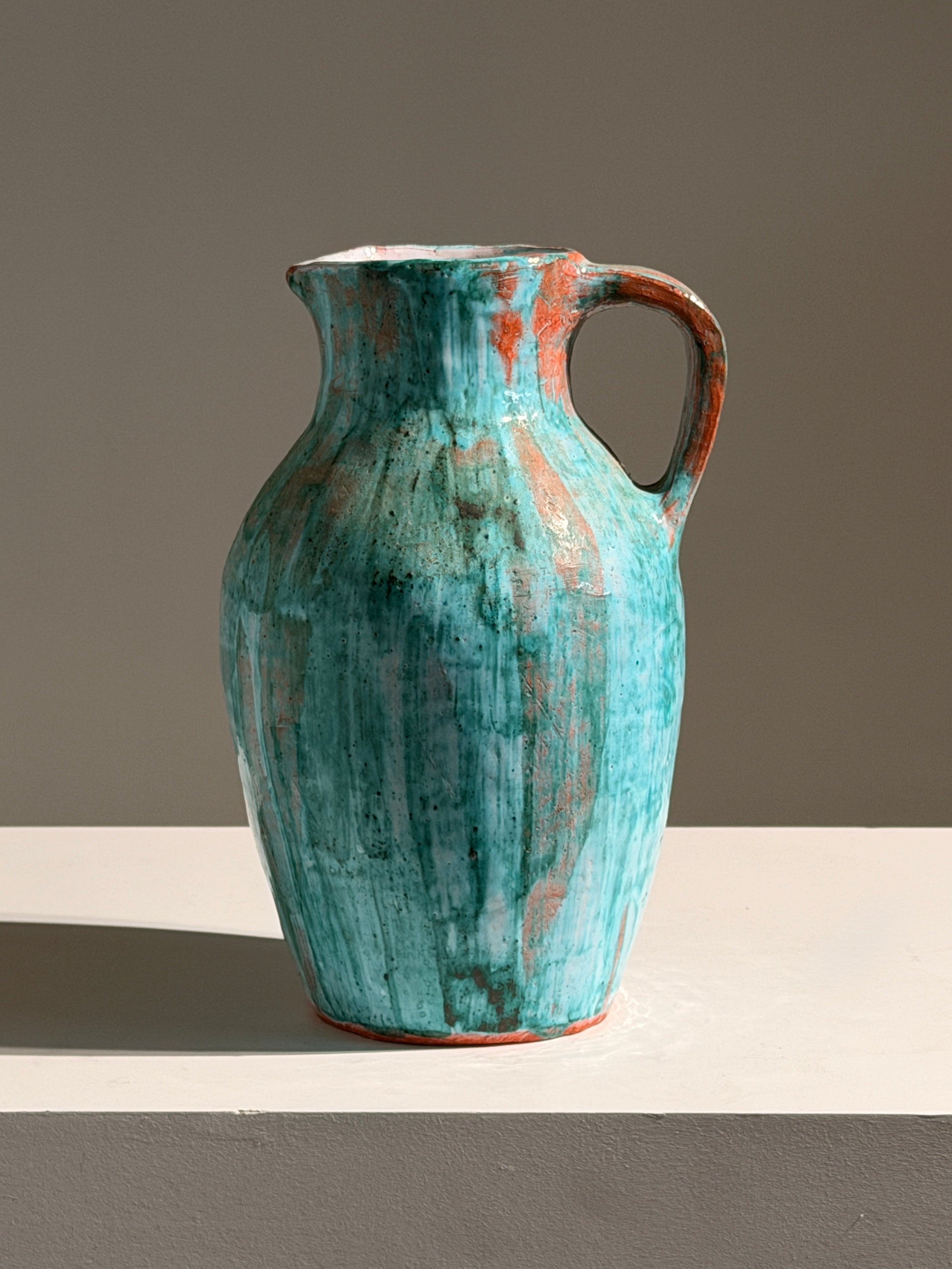 Large pitcher in green glazed earthenware, south of France, circa 1960. — side angle