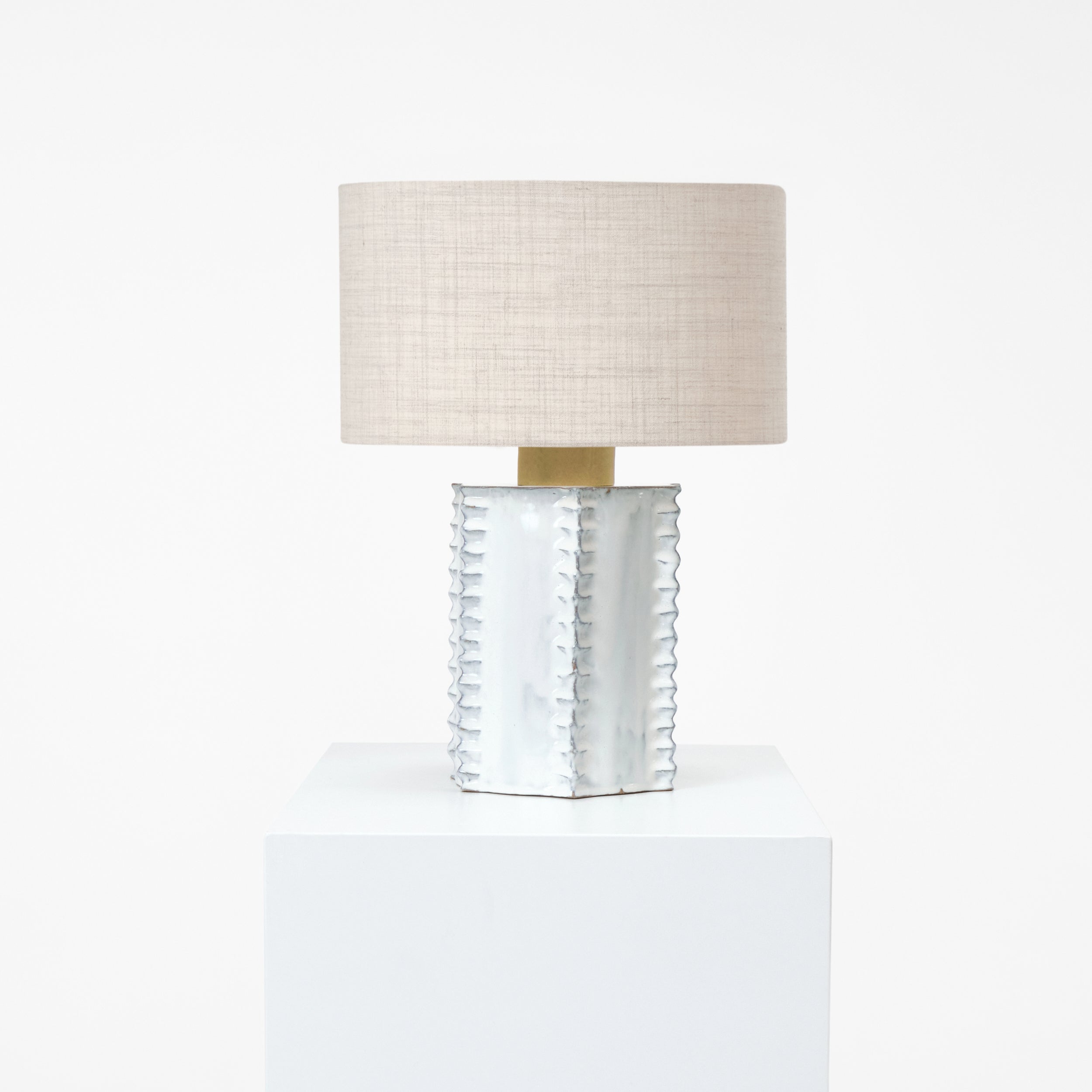 Totem Table Light — side angle showing white ceramic base and linen shade