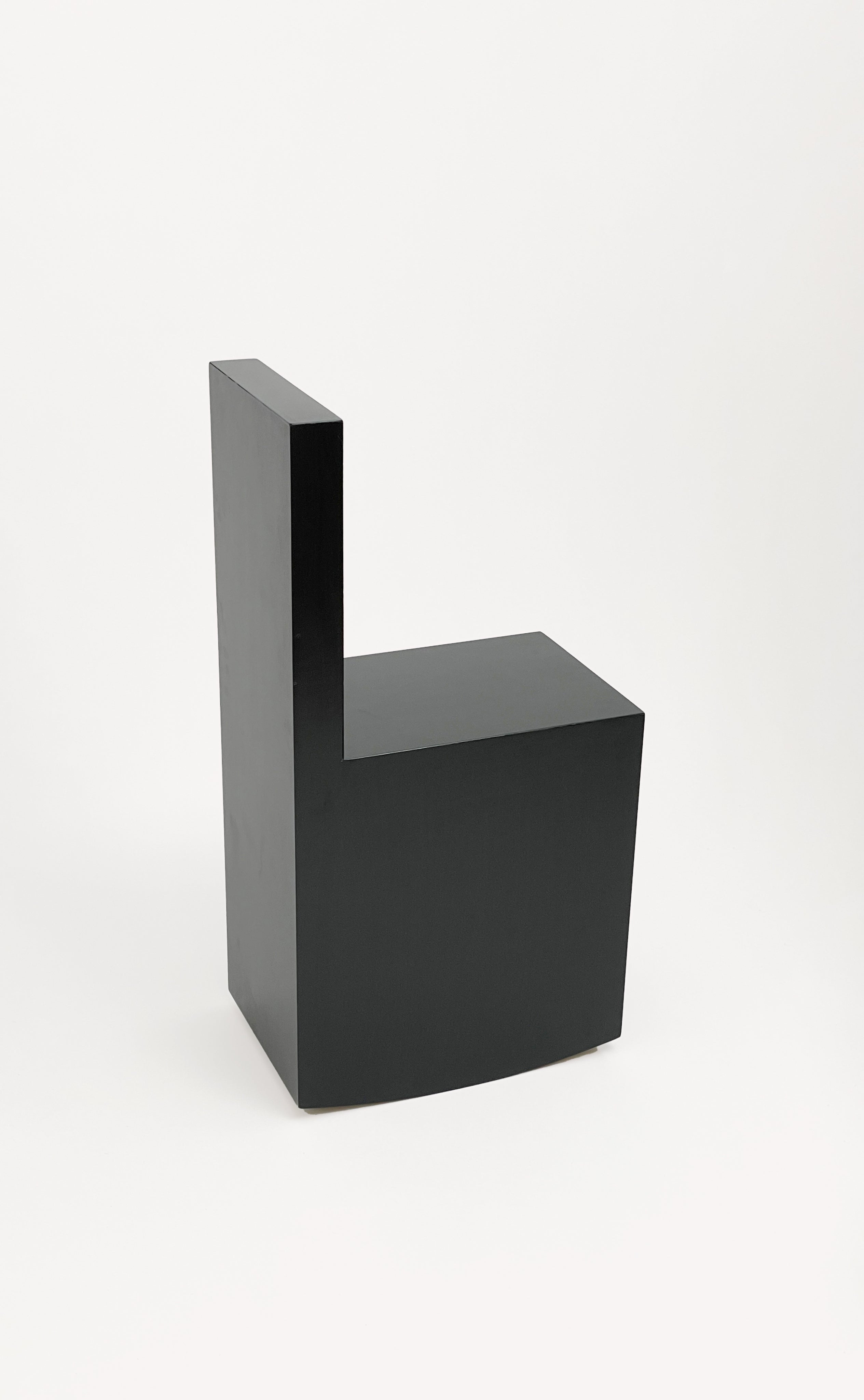 The Art Rocker Chair by GOONS features a minimalist black geometric design with a rectangular seat and straight backrest, epitomizing customizable contemporary style against a plain white background.