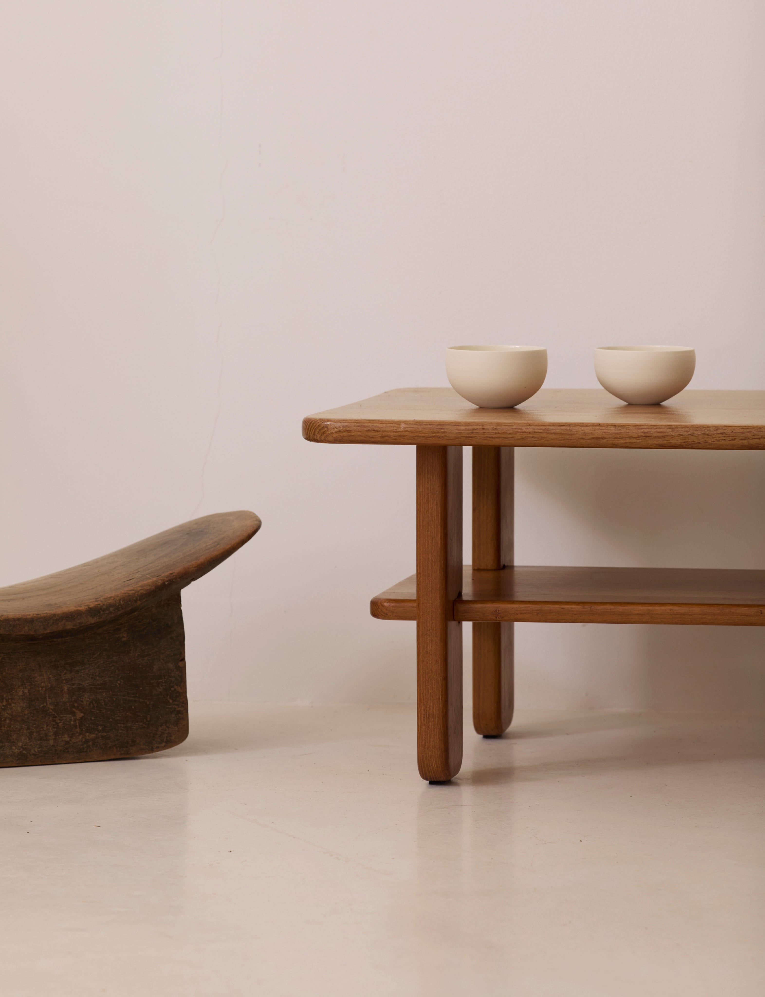 Solid elm coffee table by Alain Gaubert, France circa 1980 — angled view with two bowls on top
