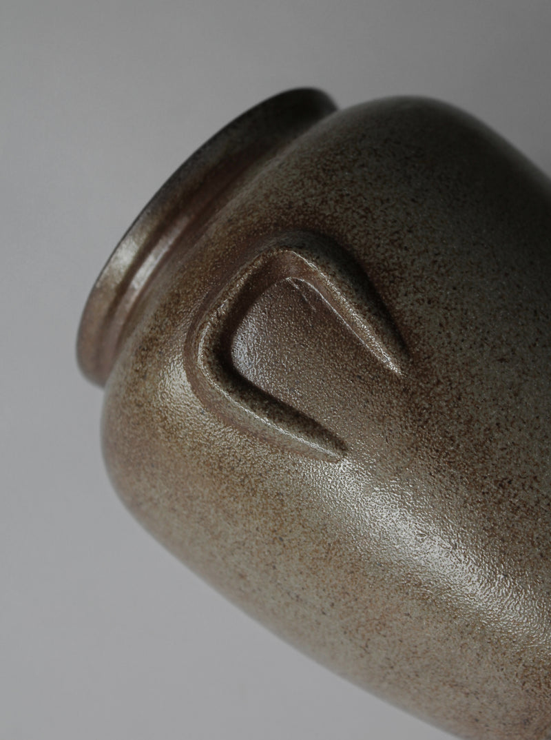 Close-up detail of vintage ceramic vase showing textured glaze