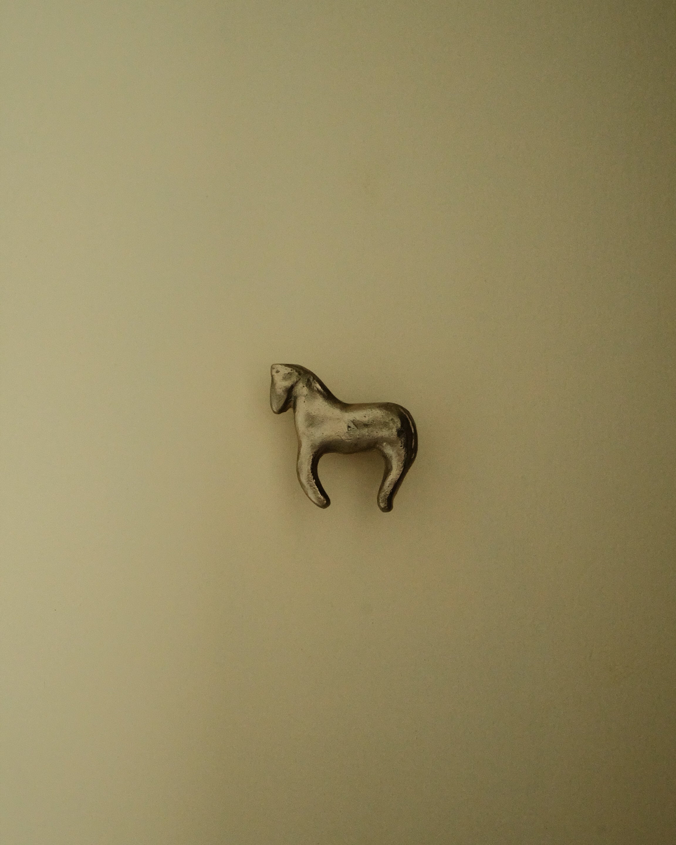 FOAL Cabinet Knob/Wall Hook — close-up of silver horse design on wall