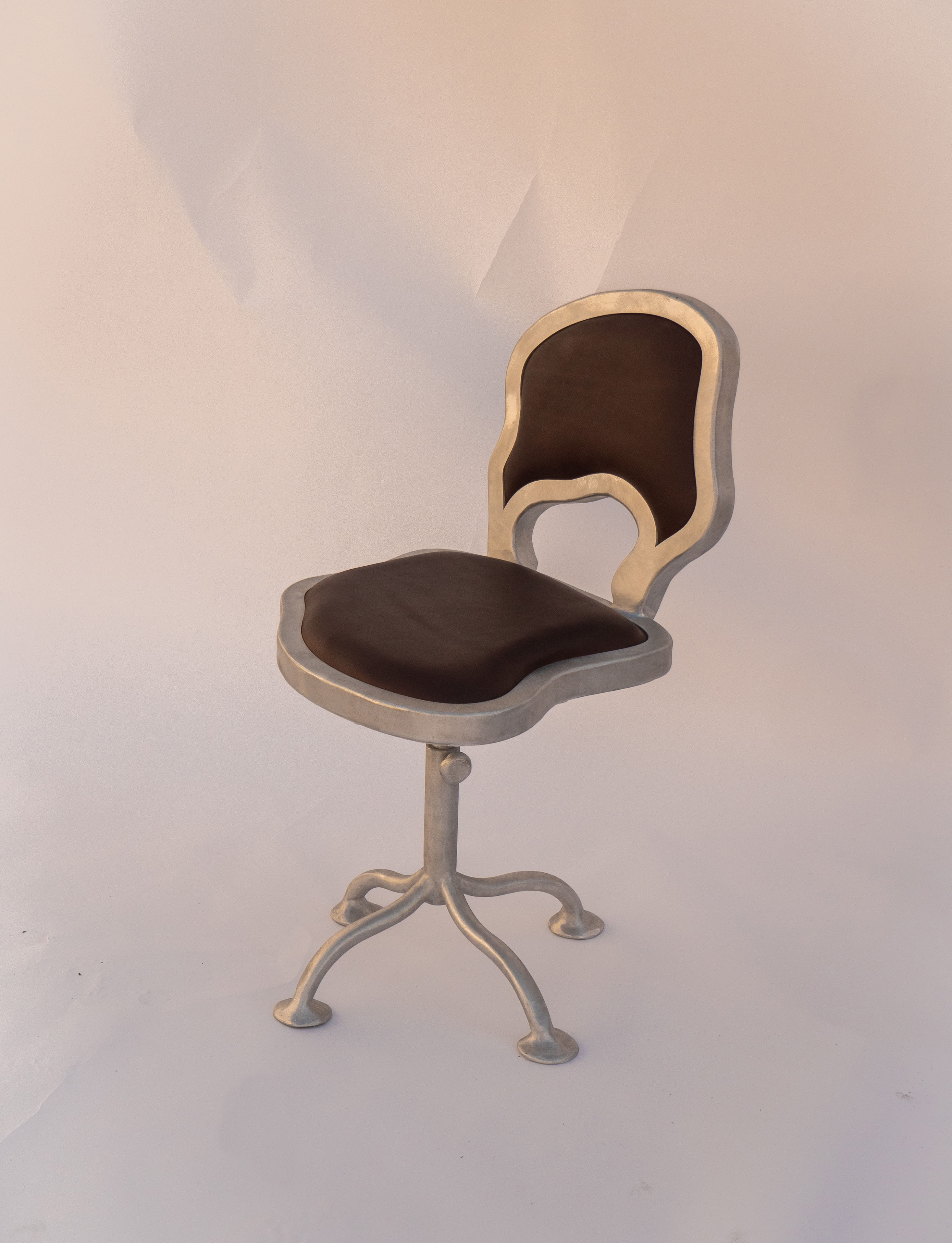 Contemporary Office Chair — angled view with metal frame and brown seat