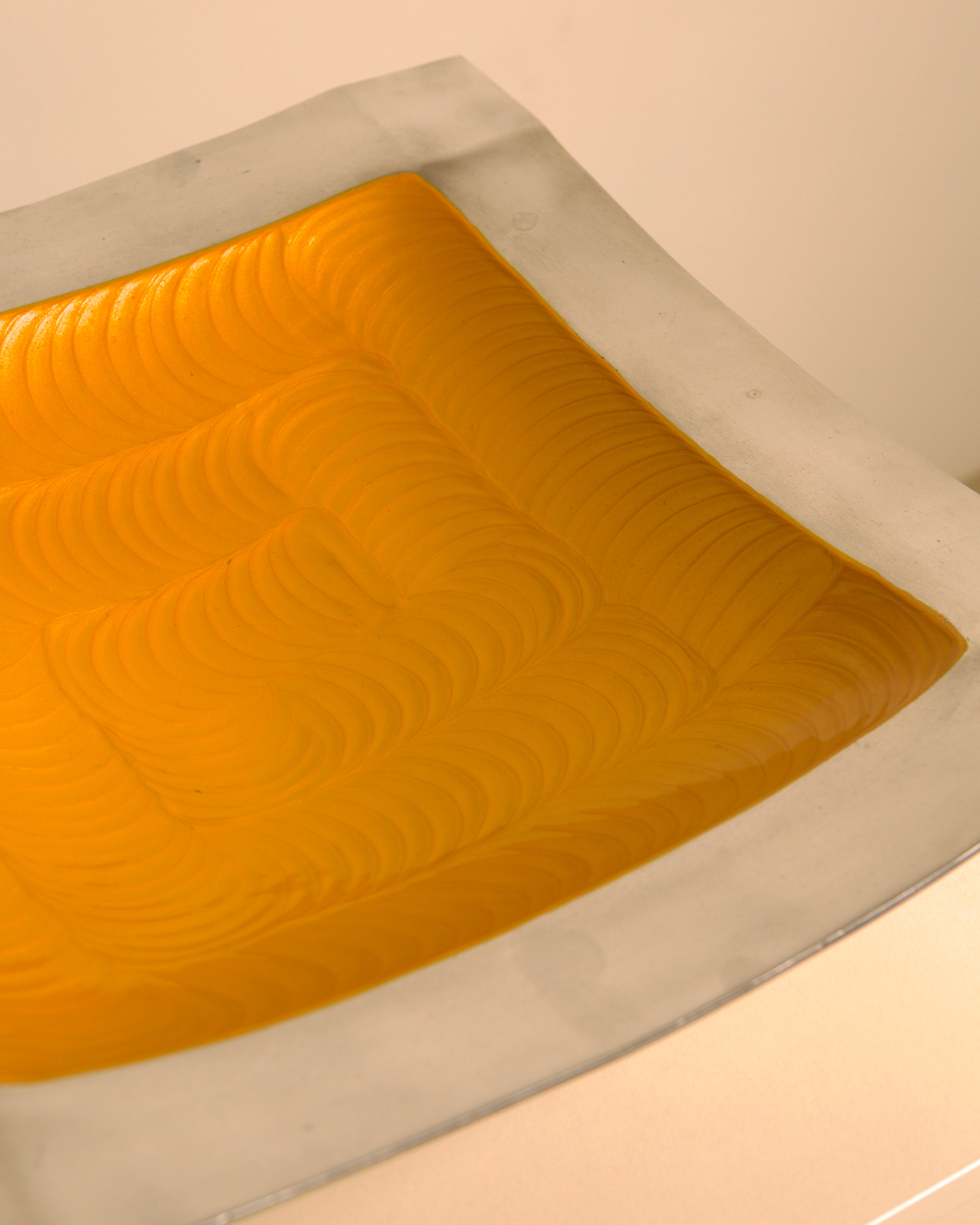 "Galassia" aluminum dish, orange center, Brandani, Italy, 1980s — lifestyle setting