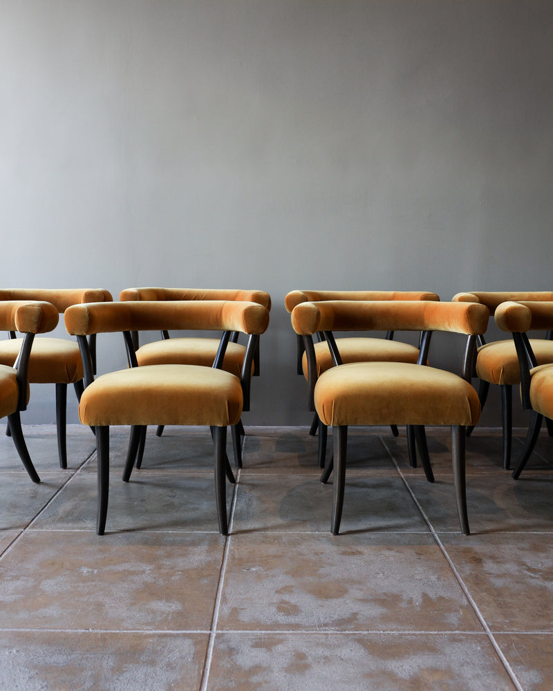 Orange velvet Josef dining chairs with black legs by Studio OSKLO