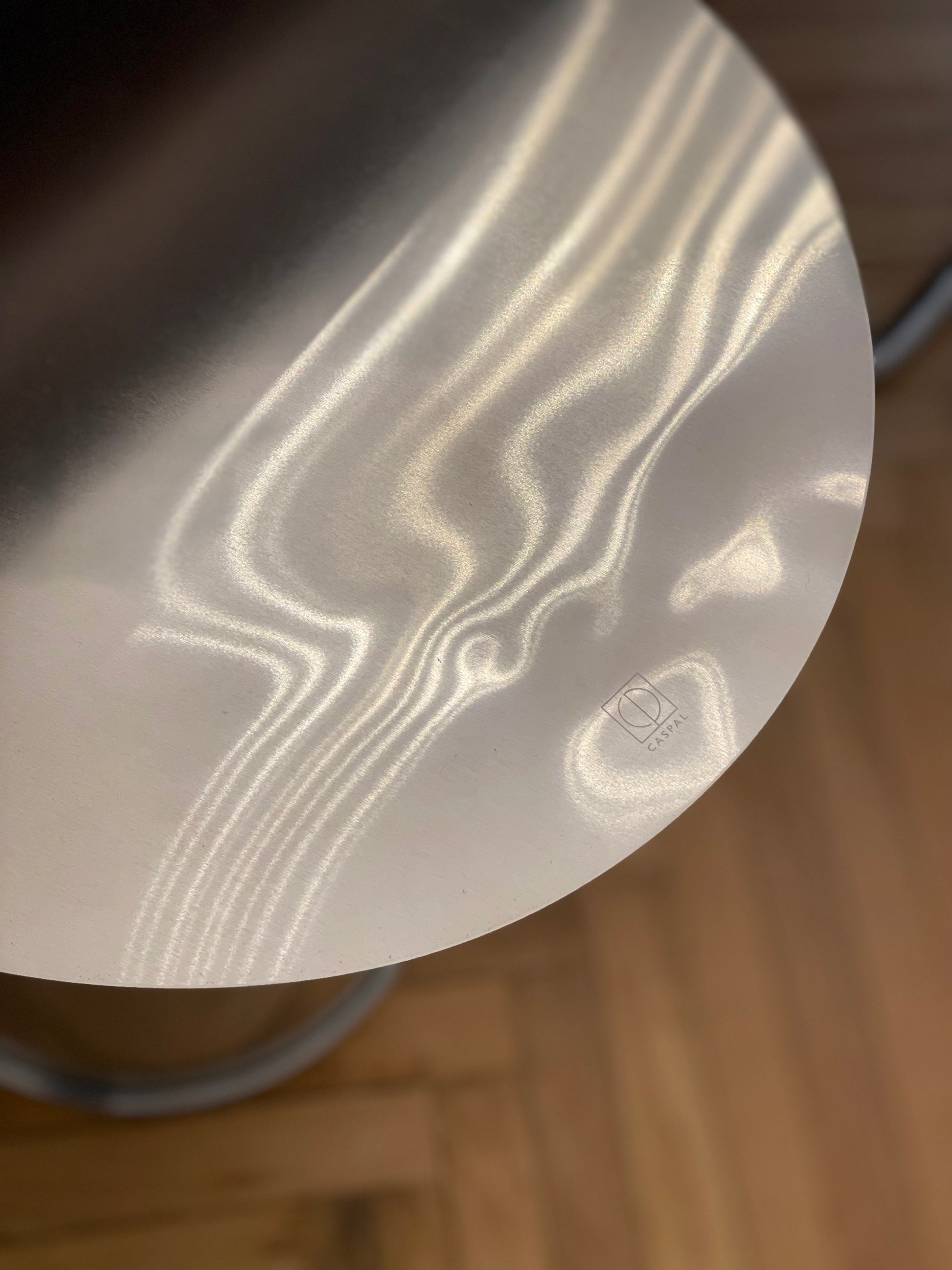 Art Deco Side Table - Mirror-Polished Metal Collection — close-up of reflective metal surface