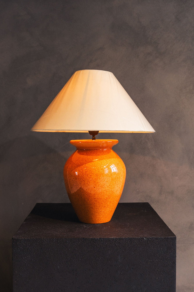 Orange ceramic table lamp with white conical shade by Robert Kostka