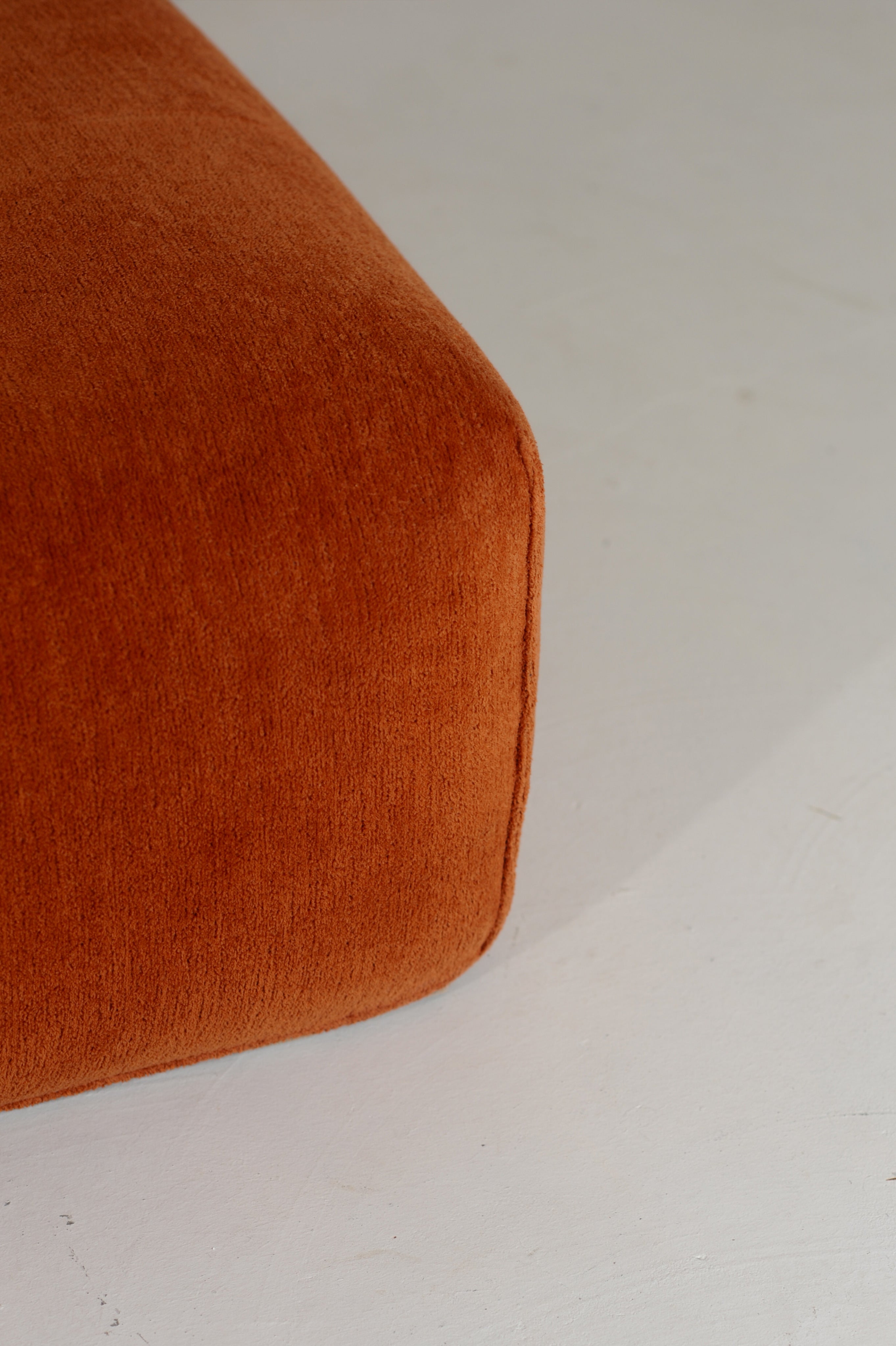 Orange fabric upholstery detail of Le Bambole armchair by Bellini