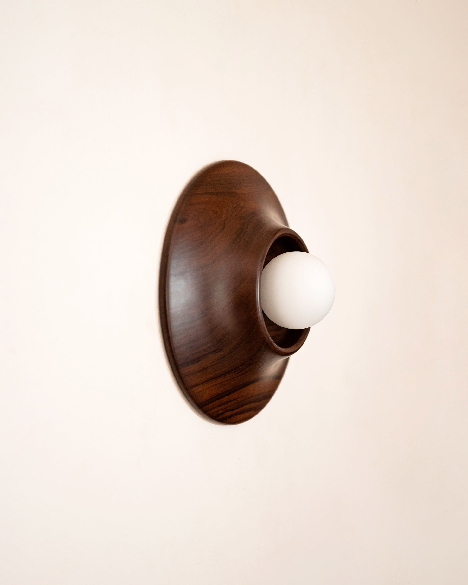 Paten Wall Light — top view of walnut finish with globe bulb