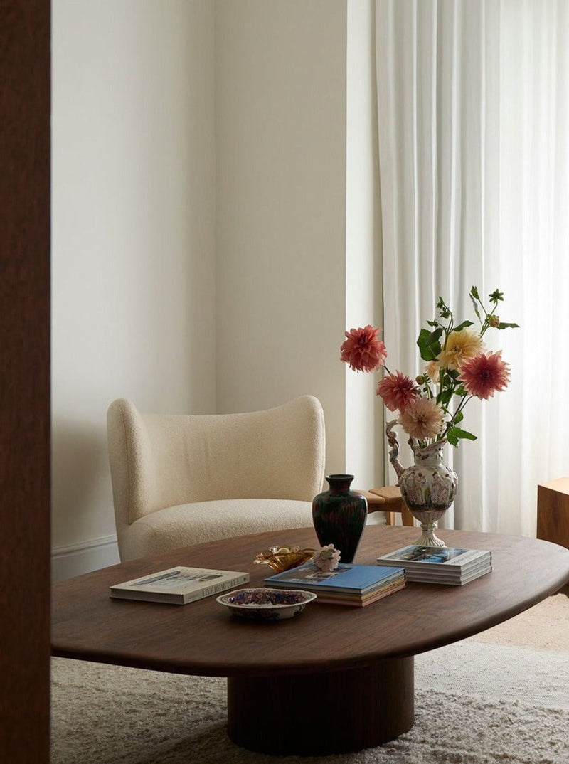 Circa Coffee Table in Walnut — close-up of rounded wood surface in living room
