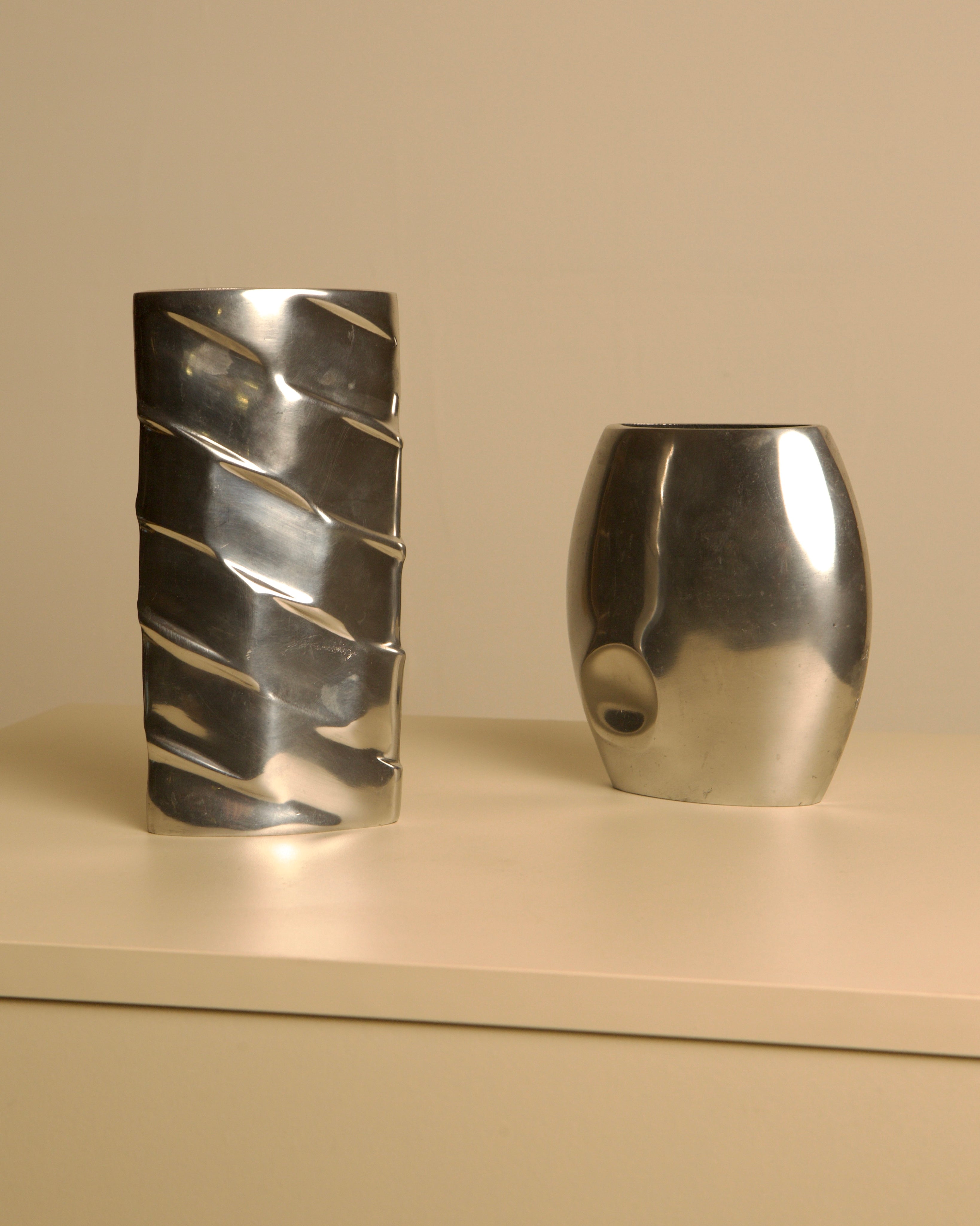 Pair of Italian Cast Aluminum Vases, 1980s — side angle on neutral background