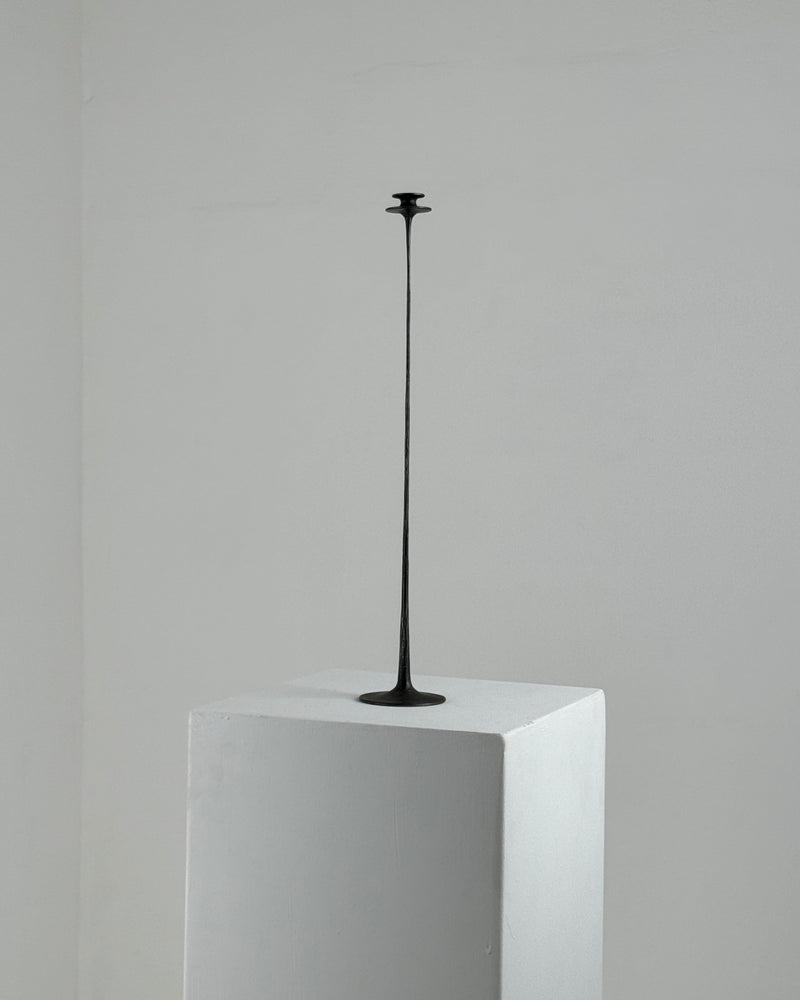 Tall black metal candleholder on white pedestal, French 1960s