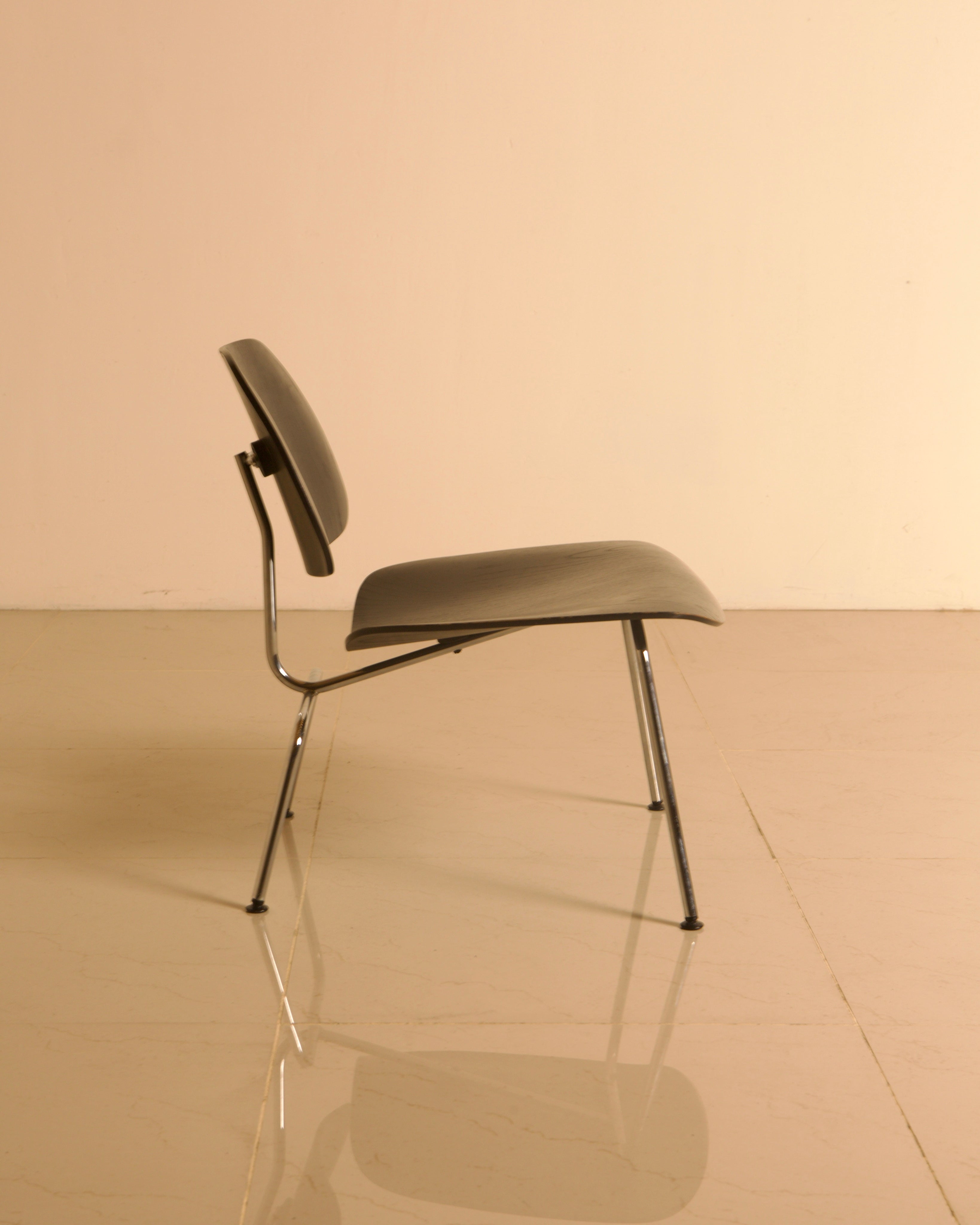 LCM Chairs by Charles and Ray Eames for Herman Miller, 1960s — side view highlighting chrome legs and gray seat