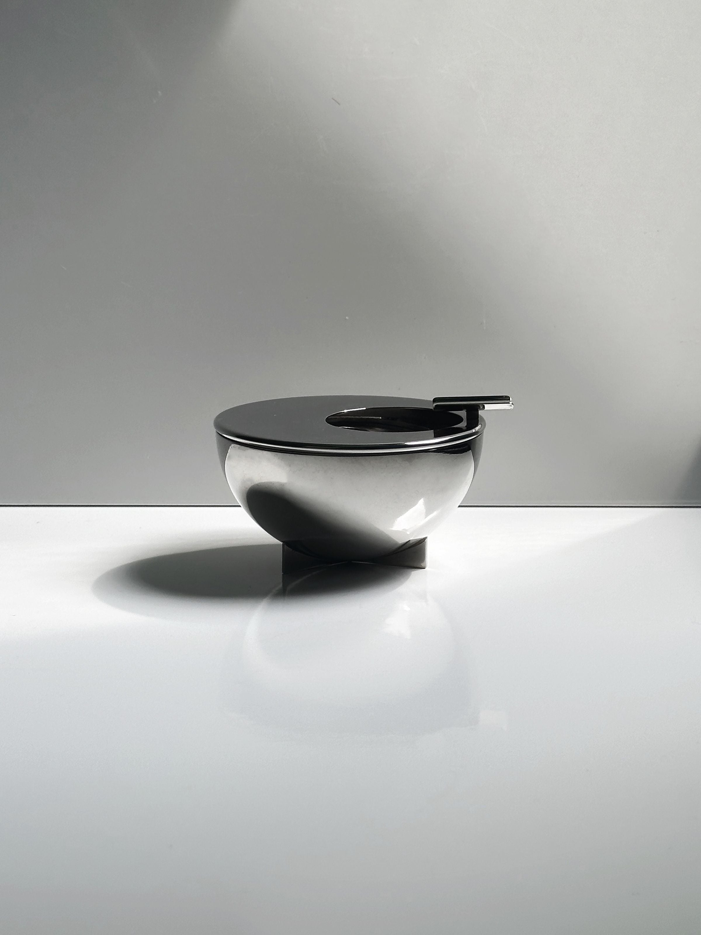 Bauhaus Ashtray by Marianne Brandt by Alessi — side angle showing polished metal finish