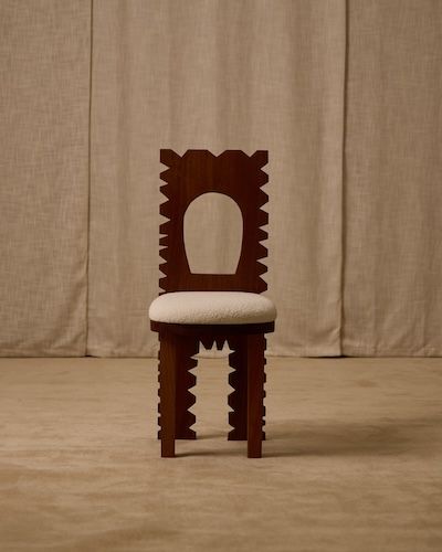 Jura sculptural dining chair with carved brown wood frame and cream seat