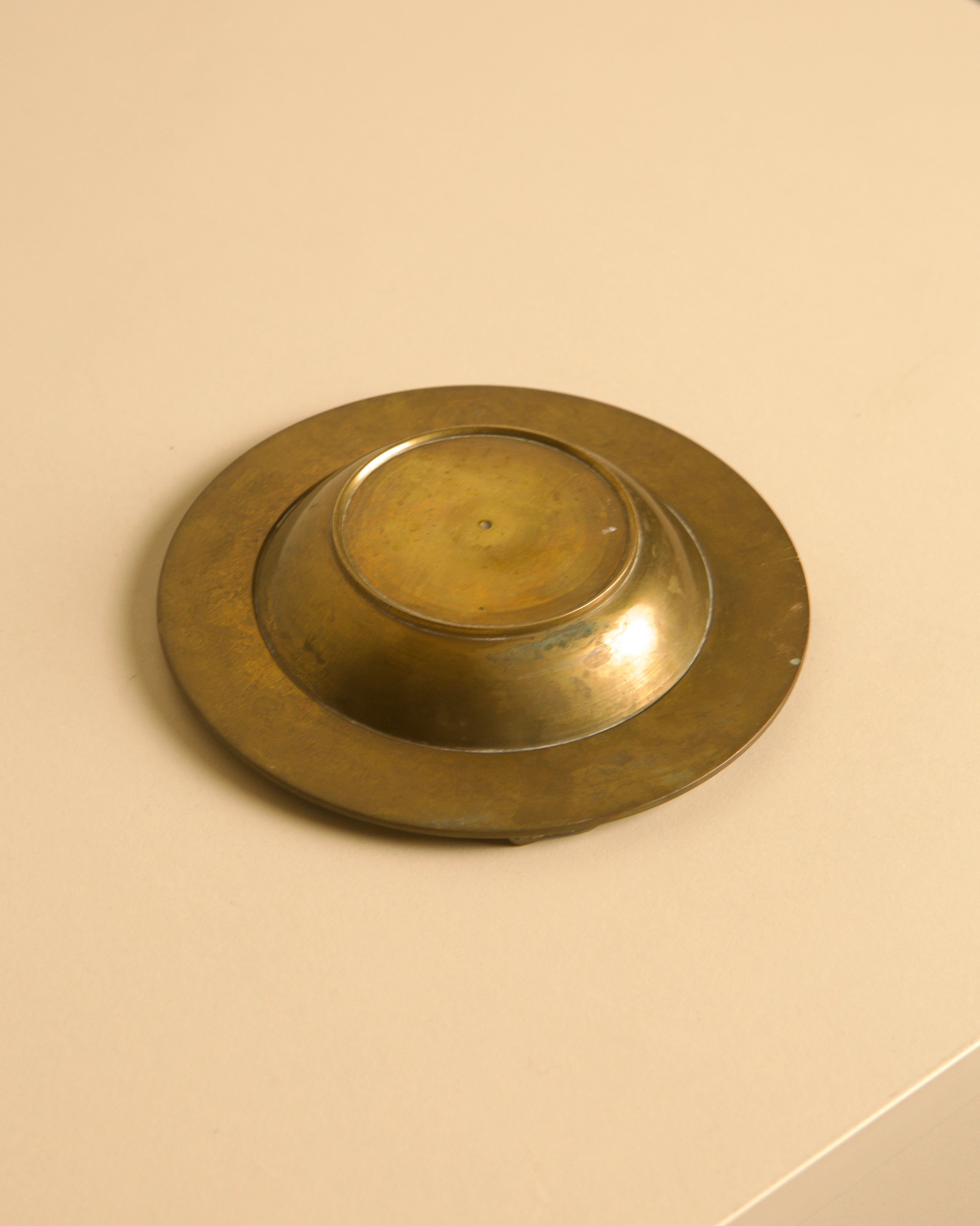 50's Brass Ashtray with Enameled Patterns — top view on neutral background
