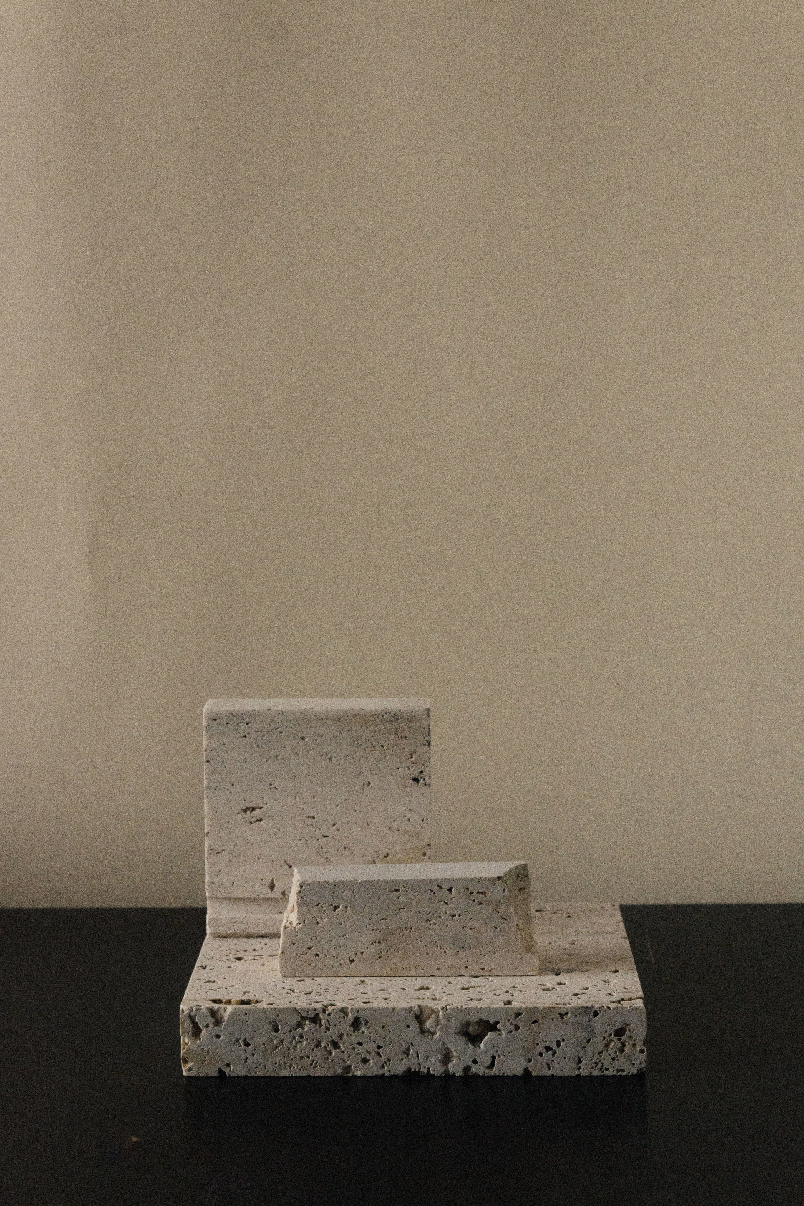 Monument II - Handmade Travertine Marble Bookstand — top view on dark surface